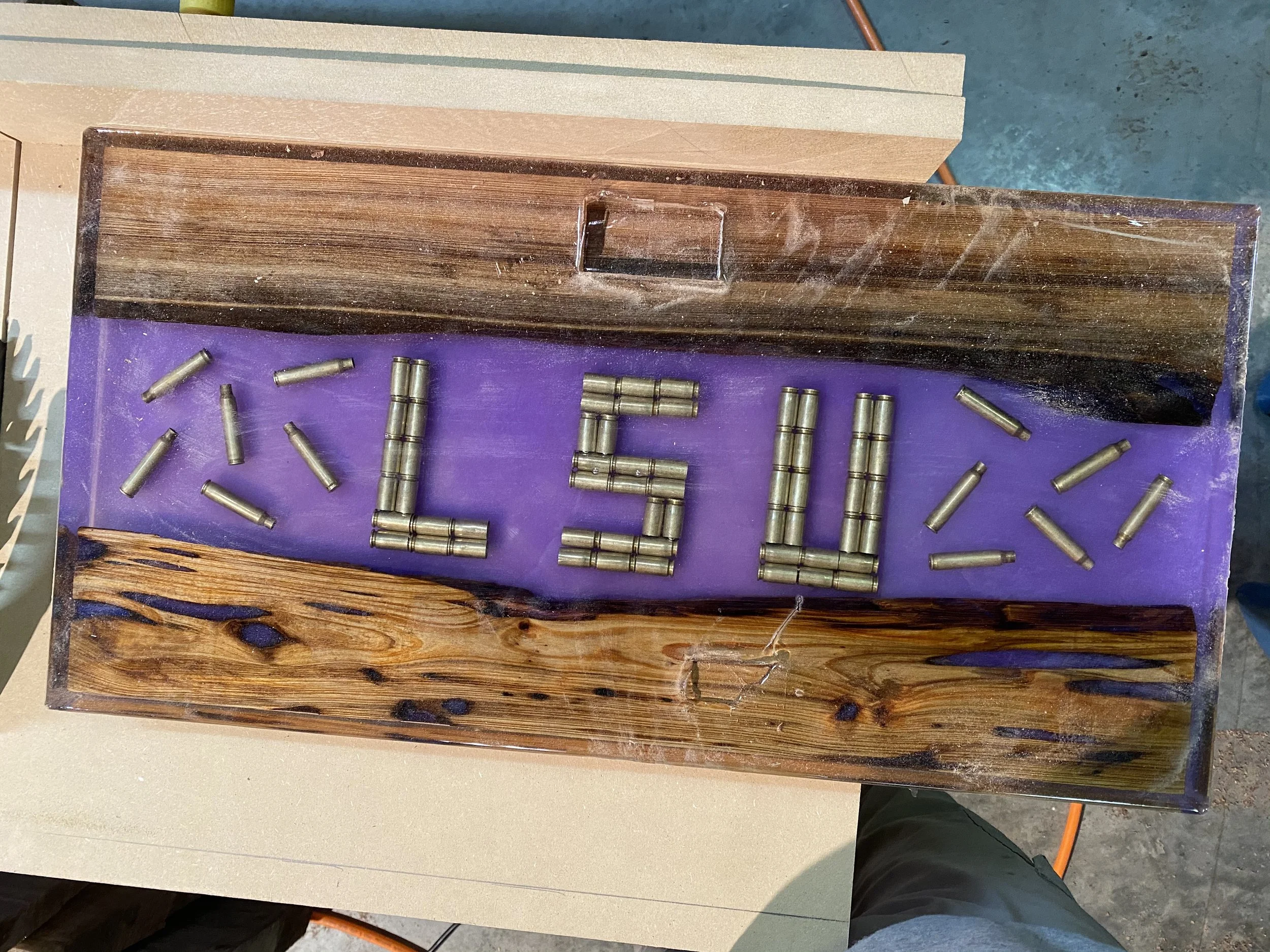 custom LSU cypress chacuterie board with clear epoxy bullets