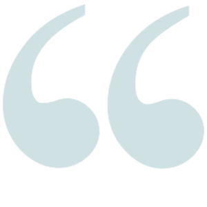 Large light blue quotation marks.