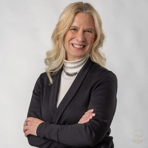 Portrait of executive coach Pari Smith wearing a black blazer against a light gray background.