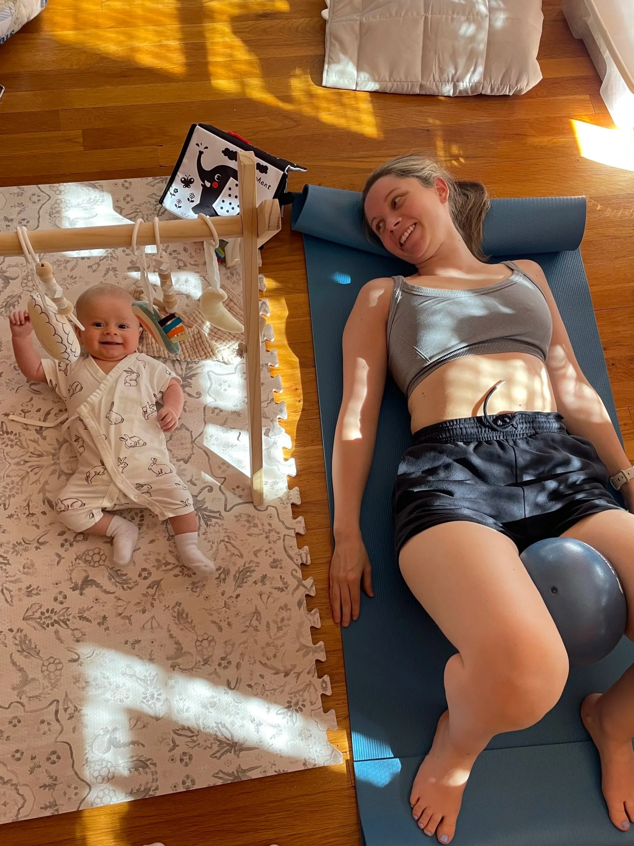 Kristin performing postpartum core rehabilitation exercises at home with her baby