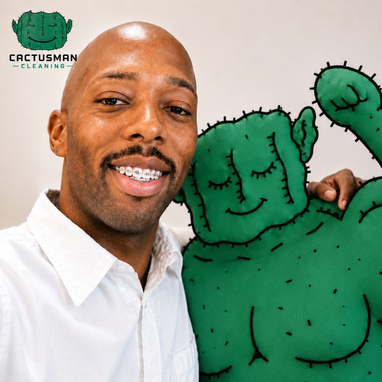 A smiling man with a shaved head and braces on his teeth next to a cartoon-style green cactus illustration with a smiling face.
