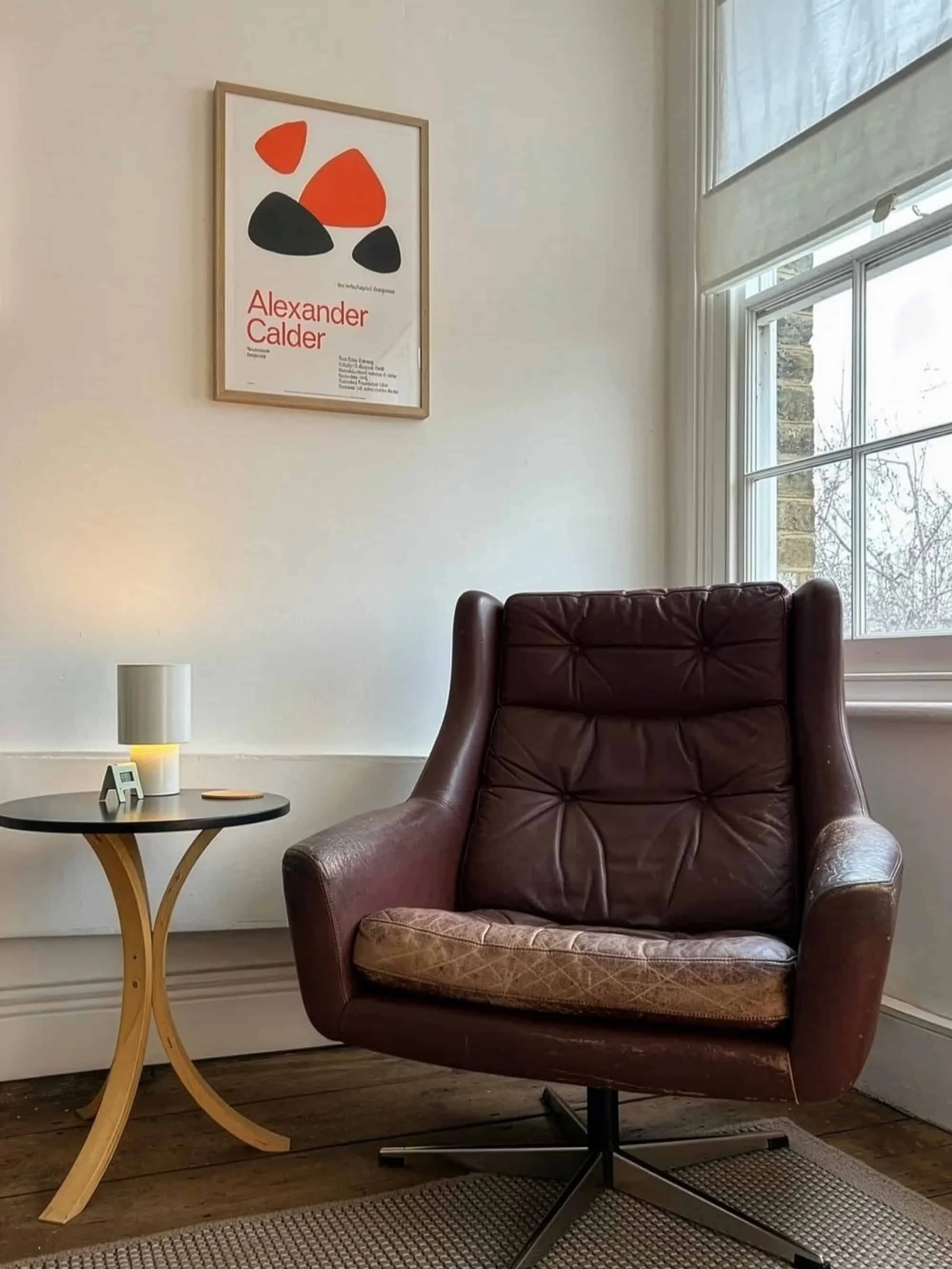 Comfortable leather armchair in the Calm Harbour Therapy room in East London, with large windows behind allowing natural light and calm space.