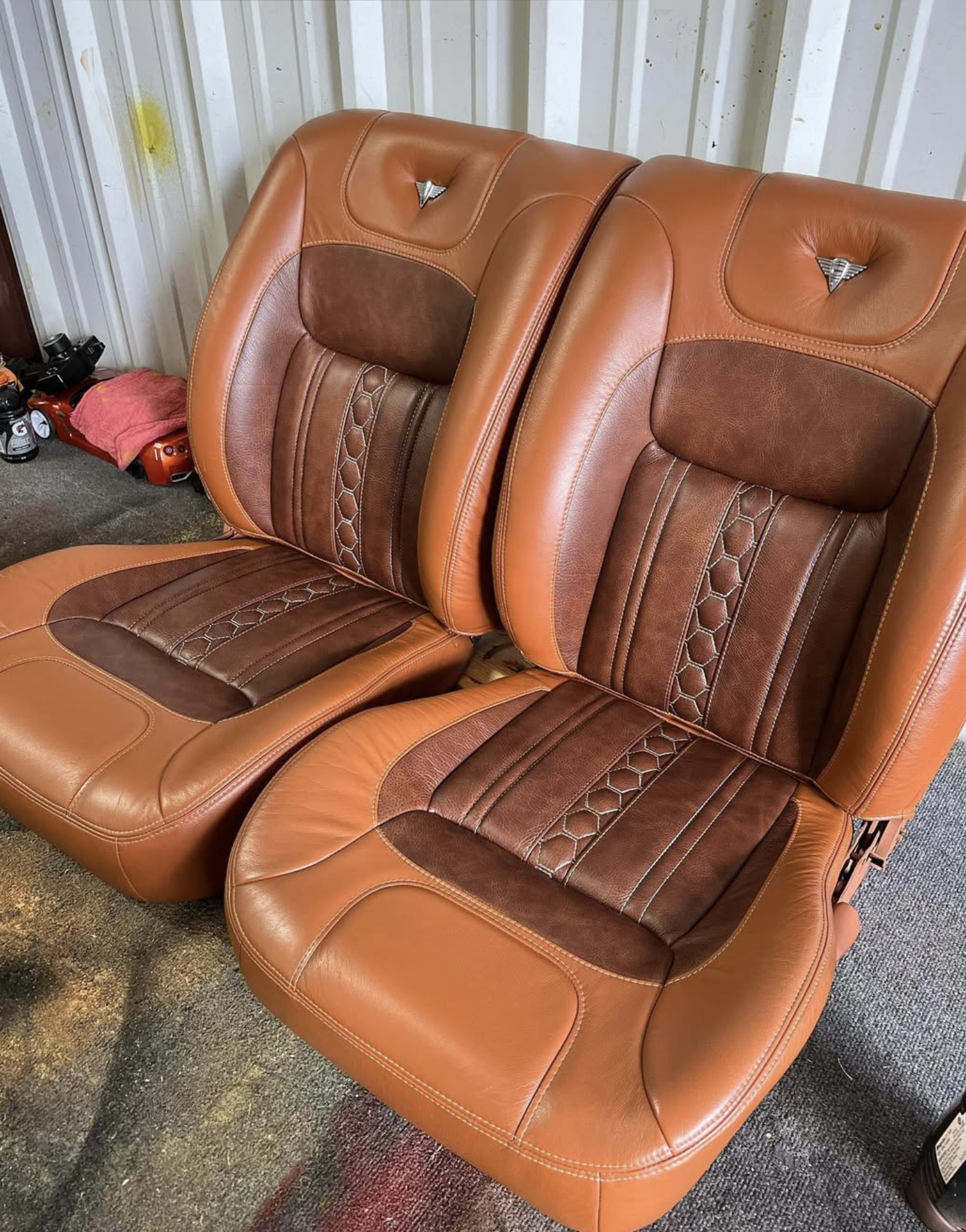 Two brown and tan custom stitched leather chairs with honeycomb pattern for a vintage truck