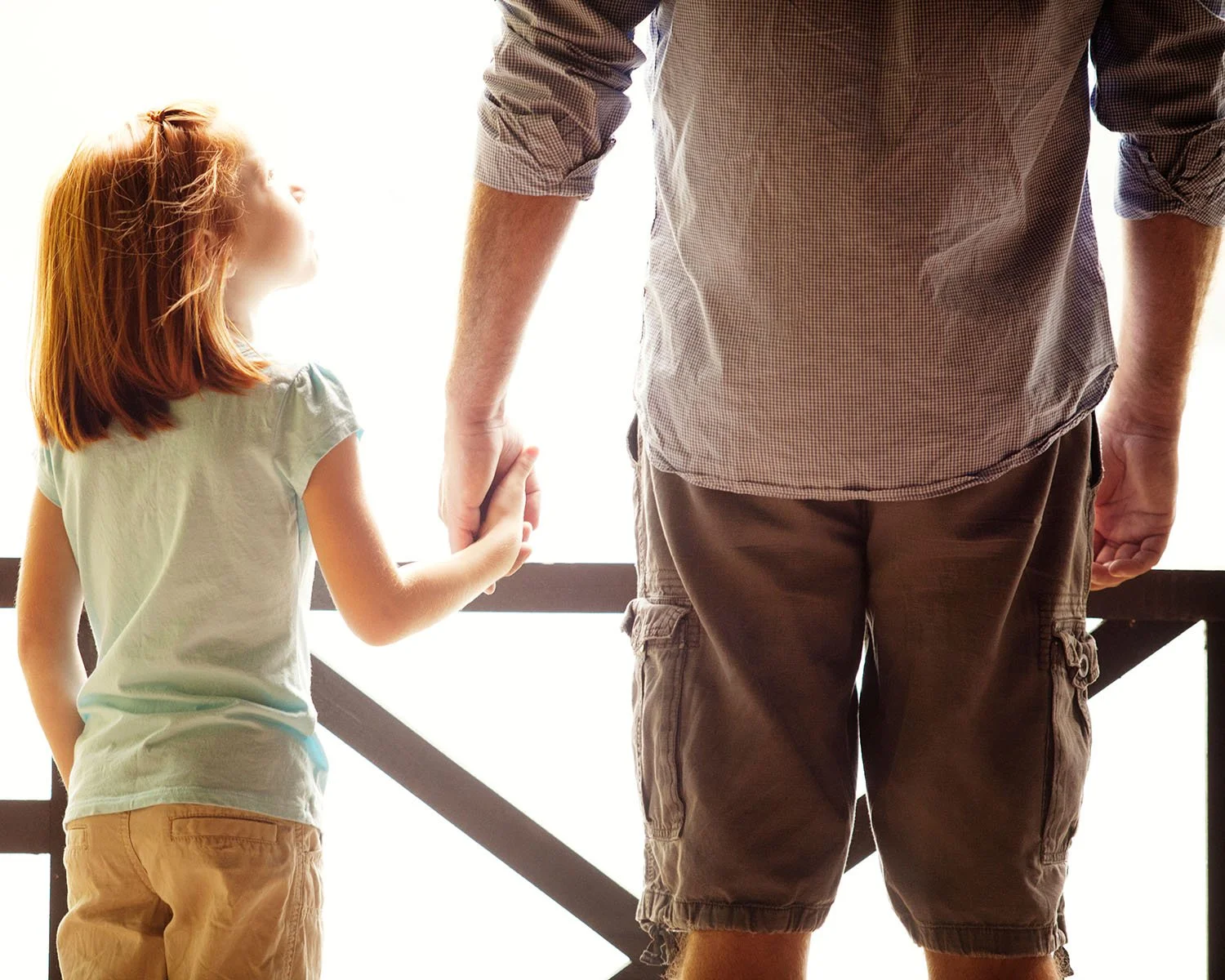 Father and daughter holding hands