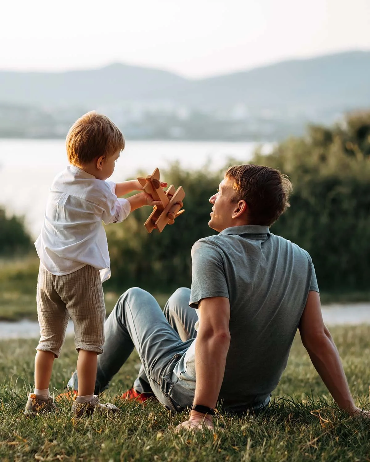 Father with son showing him an airplane