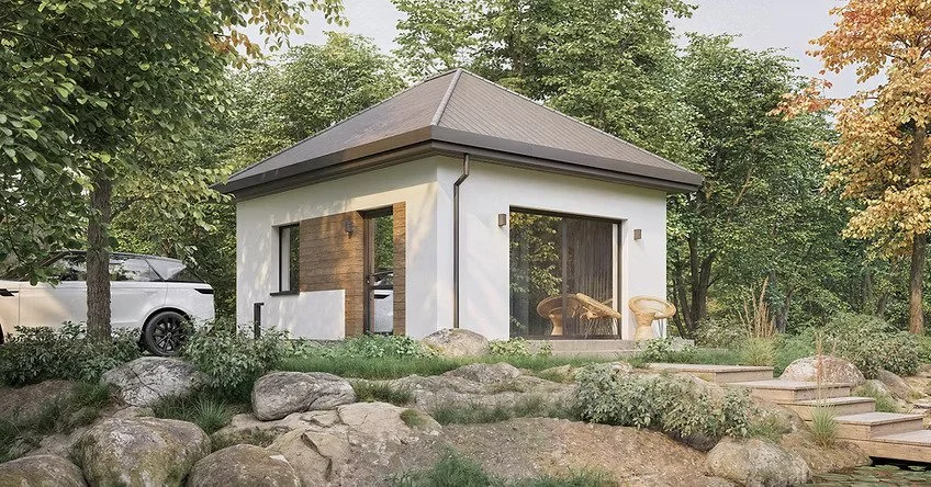 Small modern house with white walls, large glass sliding door, wooden accents, and a dark gray roof situated in a lush green garden with rocks and trees.