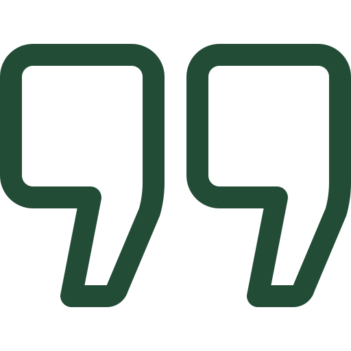 A pair of green quotation marks on a black background.