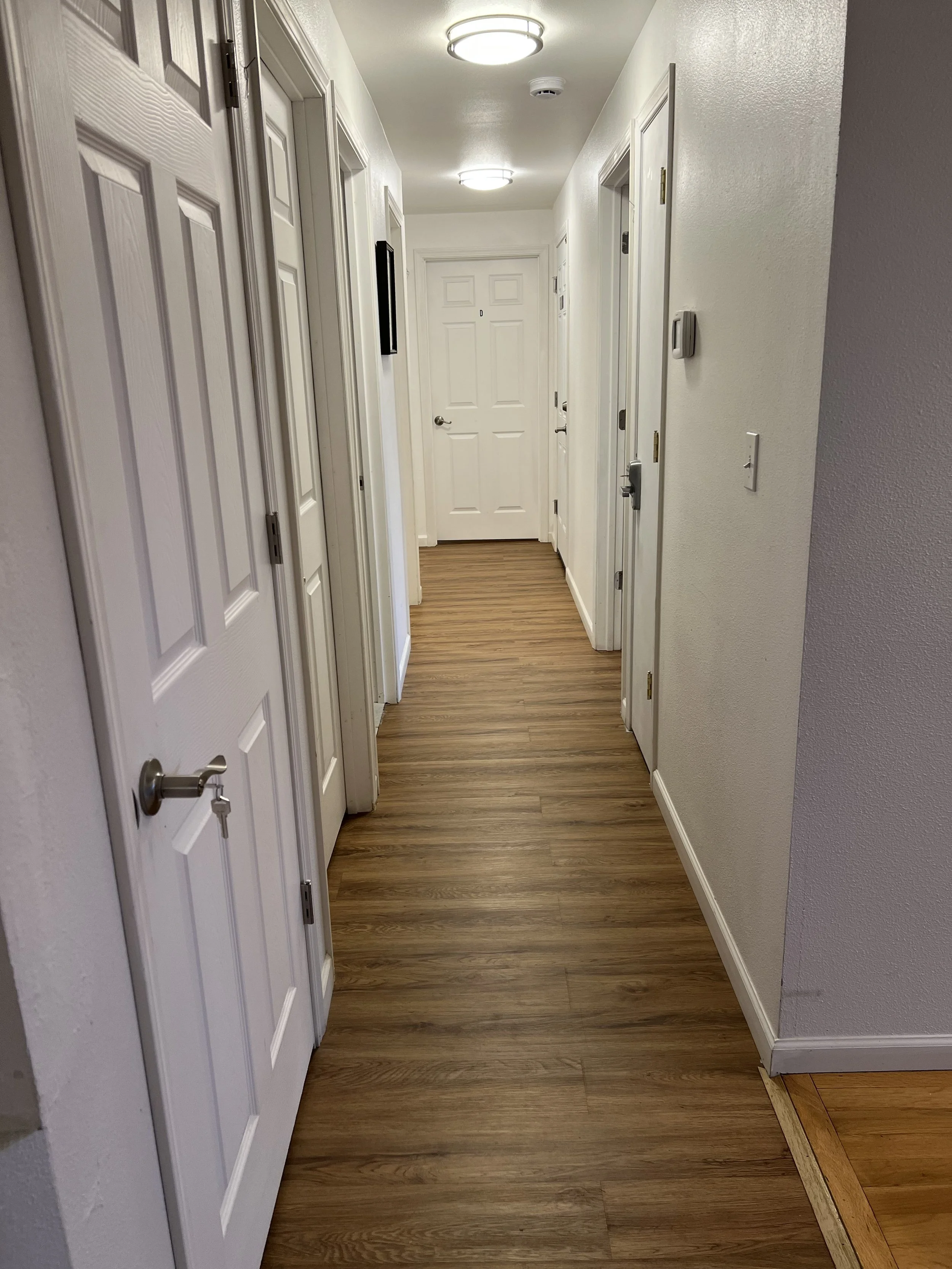 Clean and well-lit hallway at Neighbors AFH Inc Adult Family Home in Tacoma, WA, designed to provide a safe and comfortable living environment for residents.