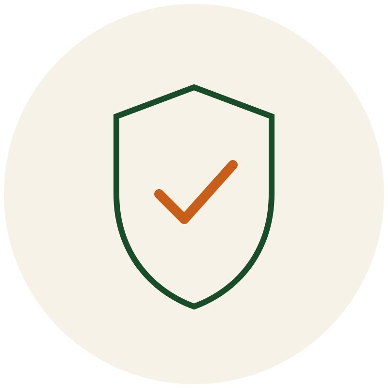 beige circular image with a green outline of a shield and an orange checkmark in the center