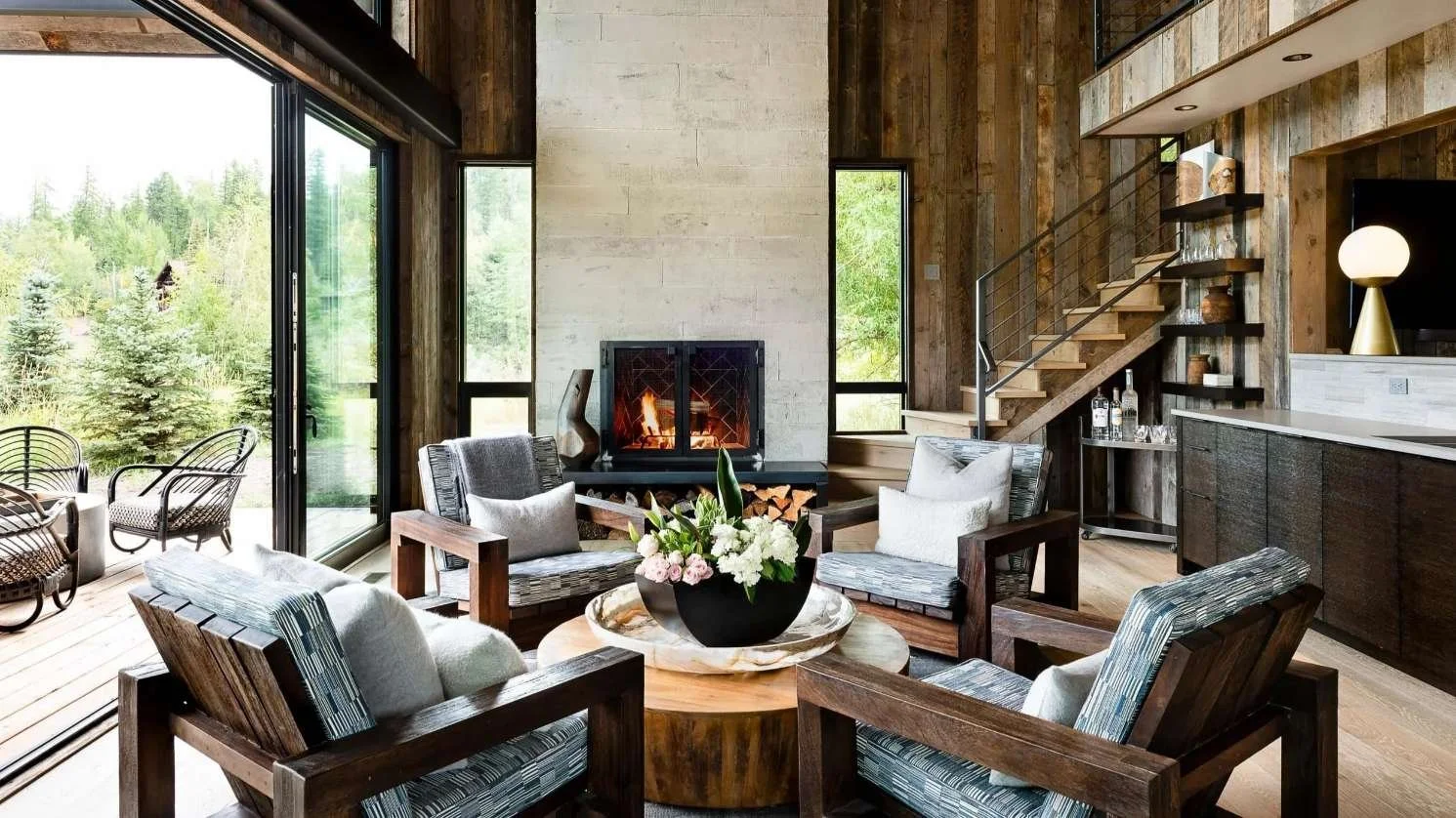 custom home living room with large white stone fireplace built by malmquist construction in montana