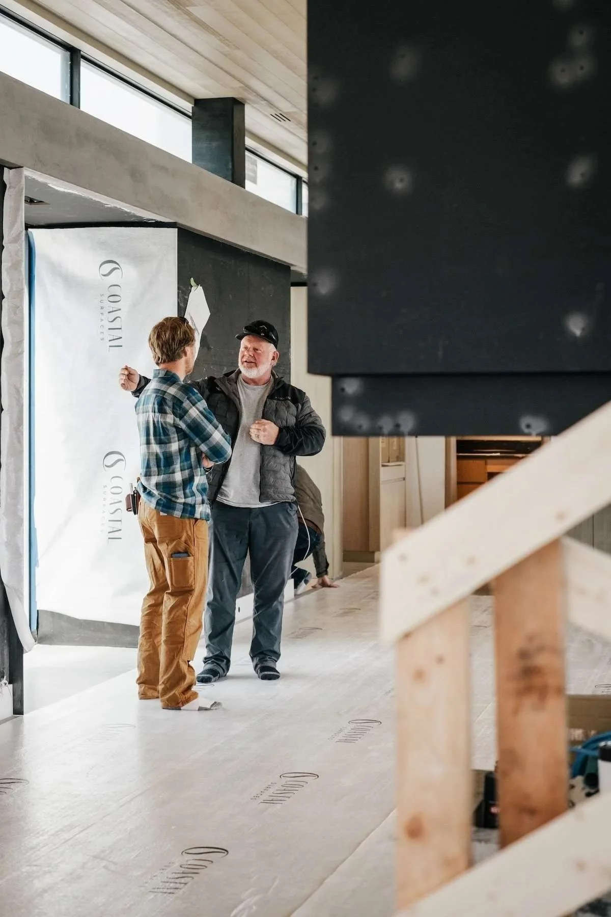 malmquist construction team talking inside a home build in progress in montana