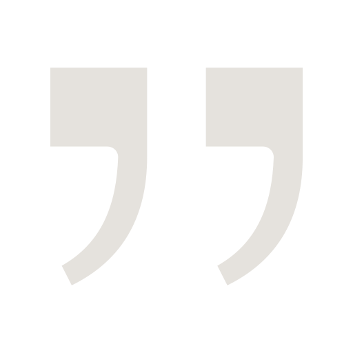 Two large gray quotation marks on a black background.