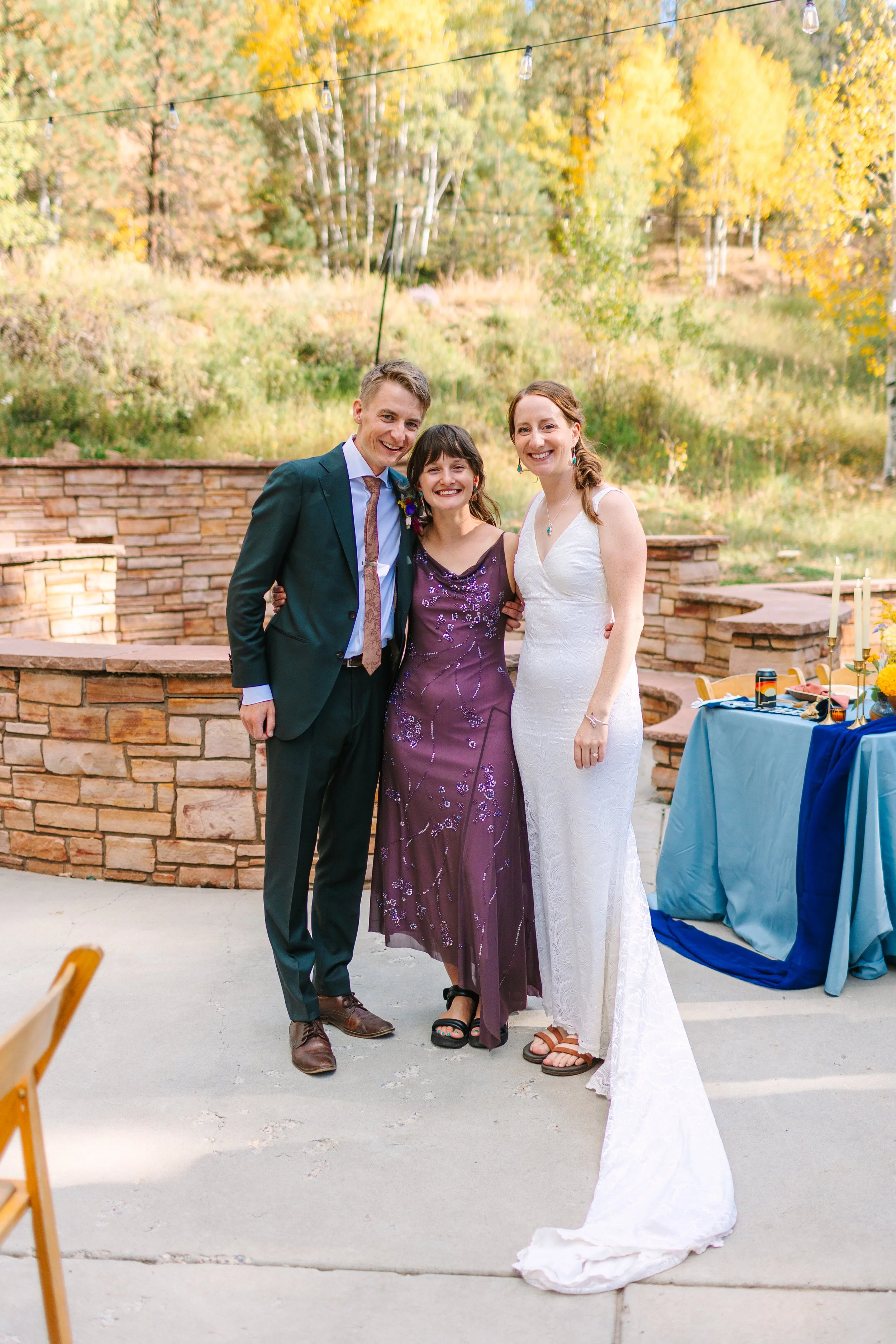 Bride and Groom stand with their planner from Bedrock Events in a warm embrace after a special wedding day in Santa Fe, NM