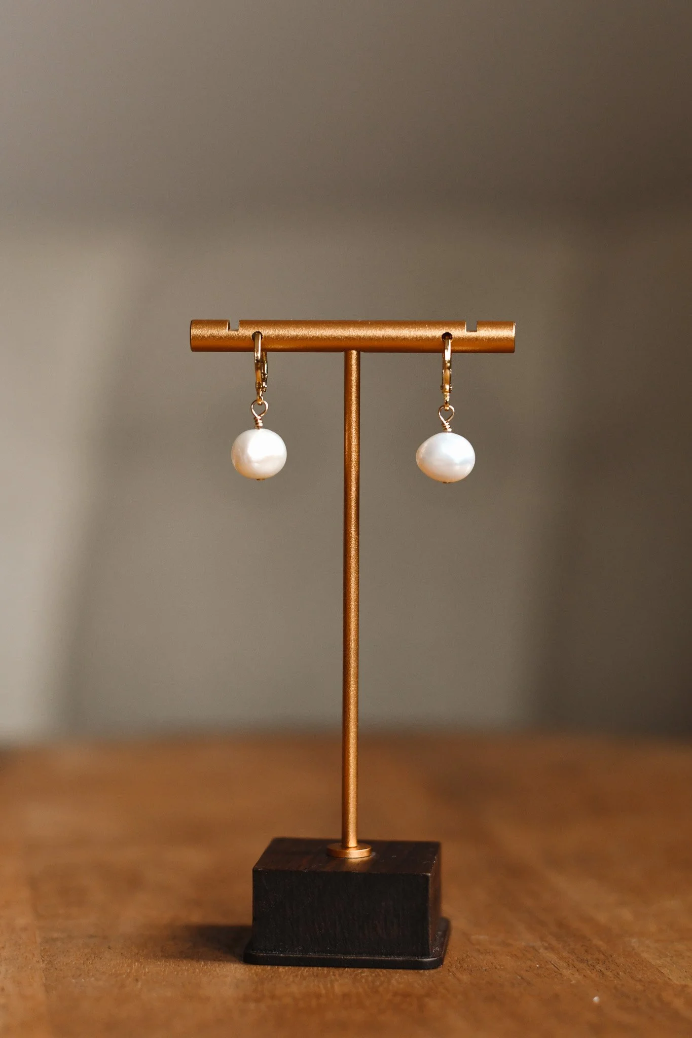 Remote product photography for a jewellery brand, featuring pearl drop earrings styled on a display stand.