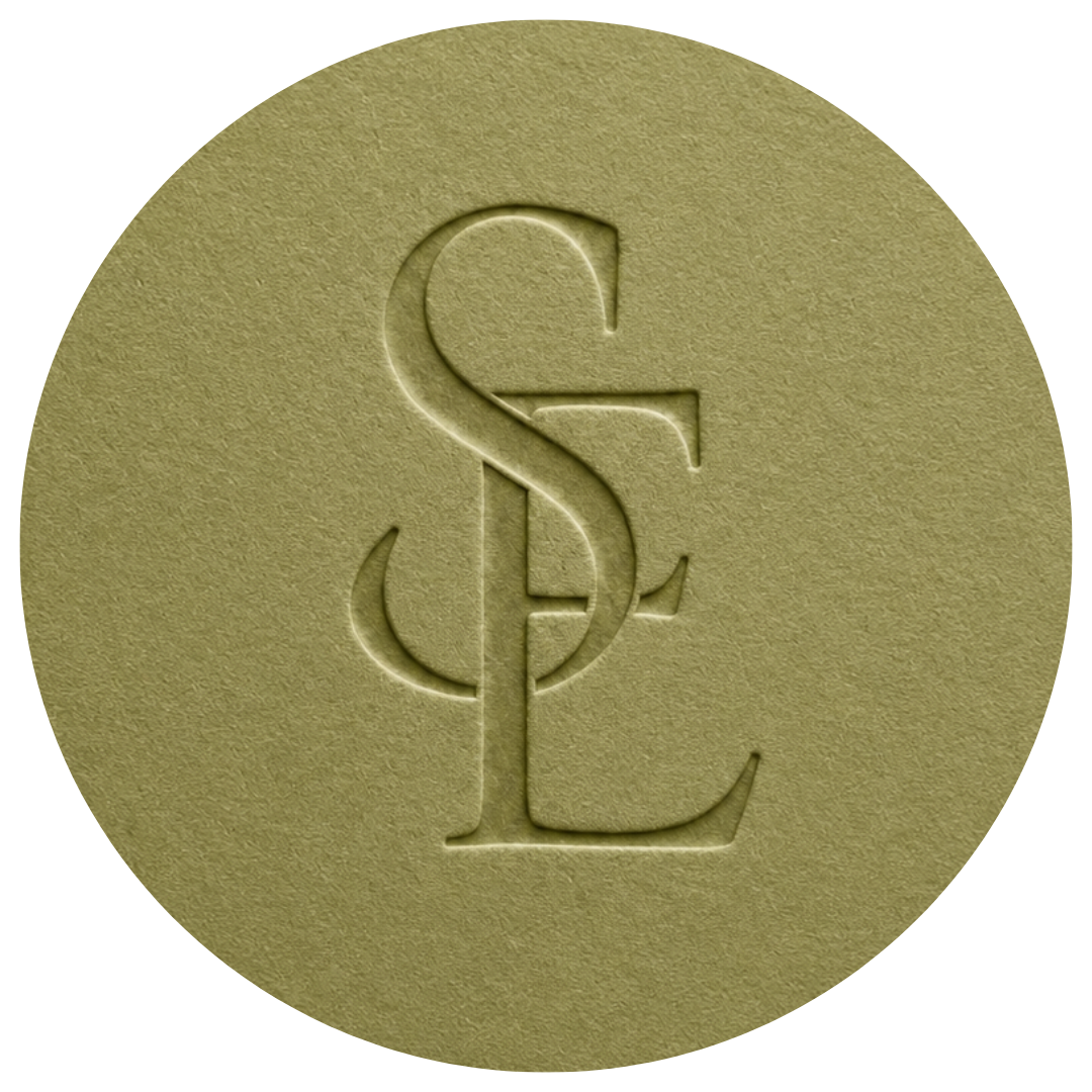 A golden coin with an embossed dollar sign ($) and the letter L.