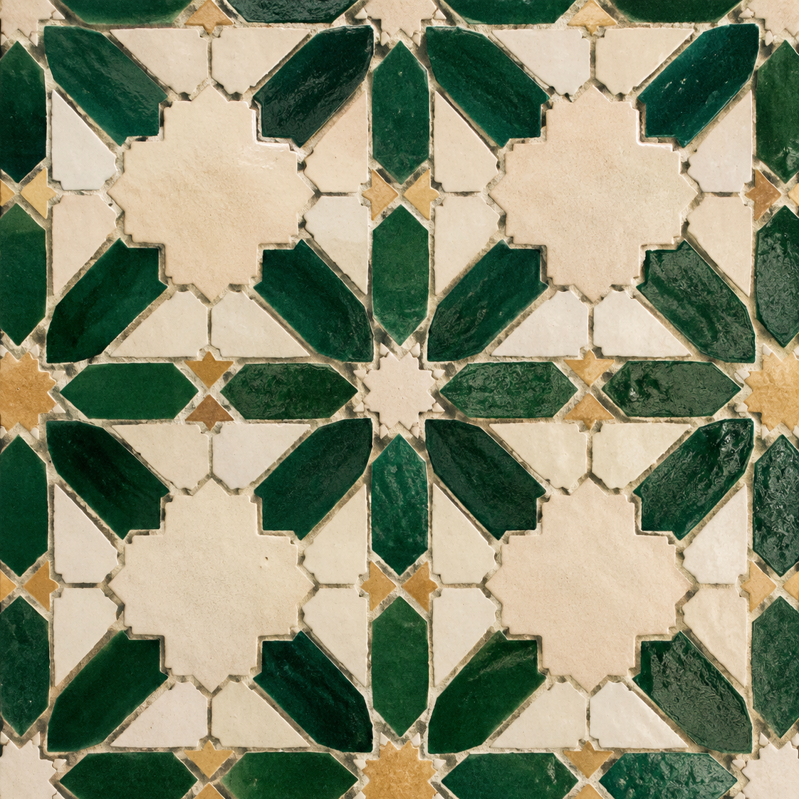 Close-up of decorative ceramic tiles with geometric pattern in green, white, and beige colors.