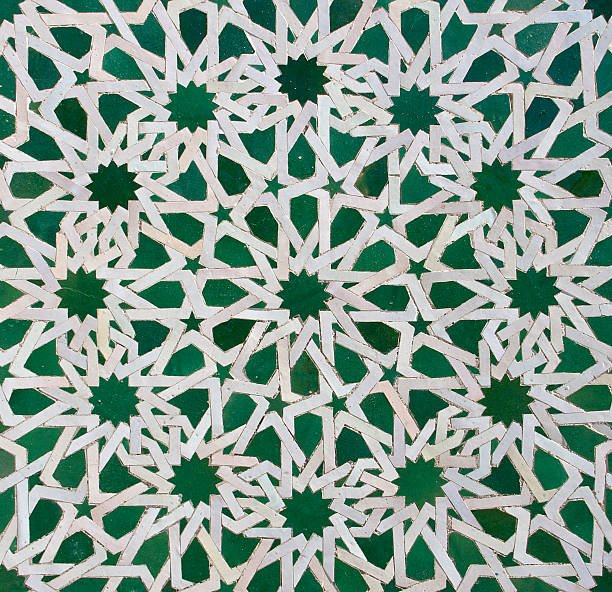 Intricate white geometric pattern with star shapes on a green background.