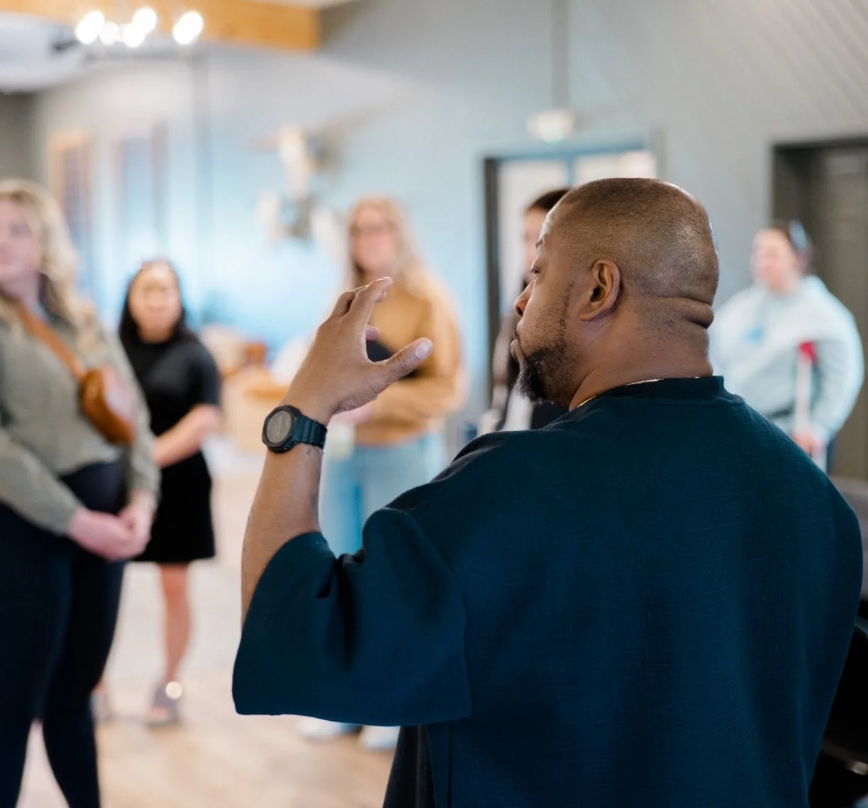 Vaney Hariri speaking to a team at the Culture Cove retreat space.