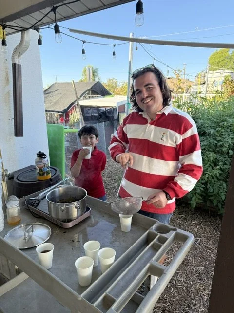 Our Farm to School Coordinator, Mr. James, making some fresh berry leaf and lemongrass tea in the school garden