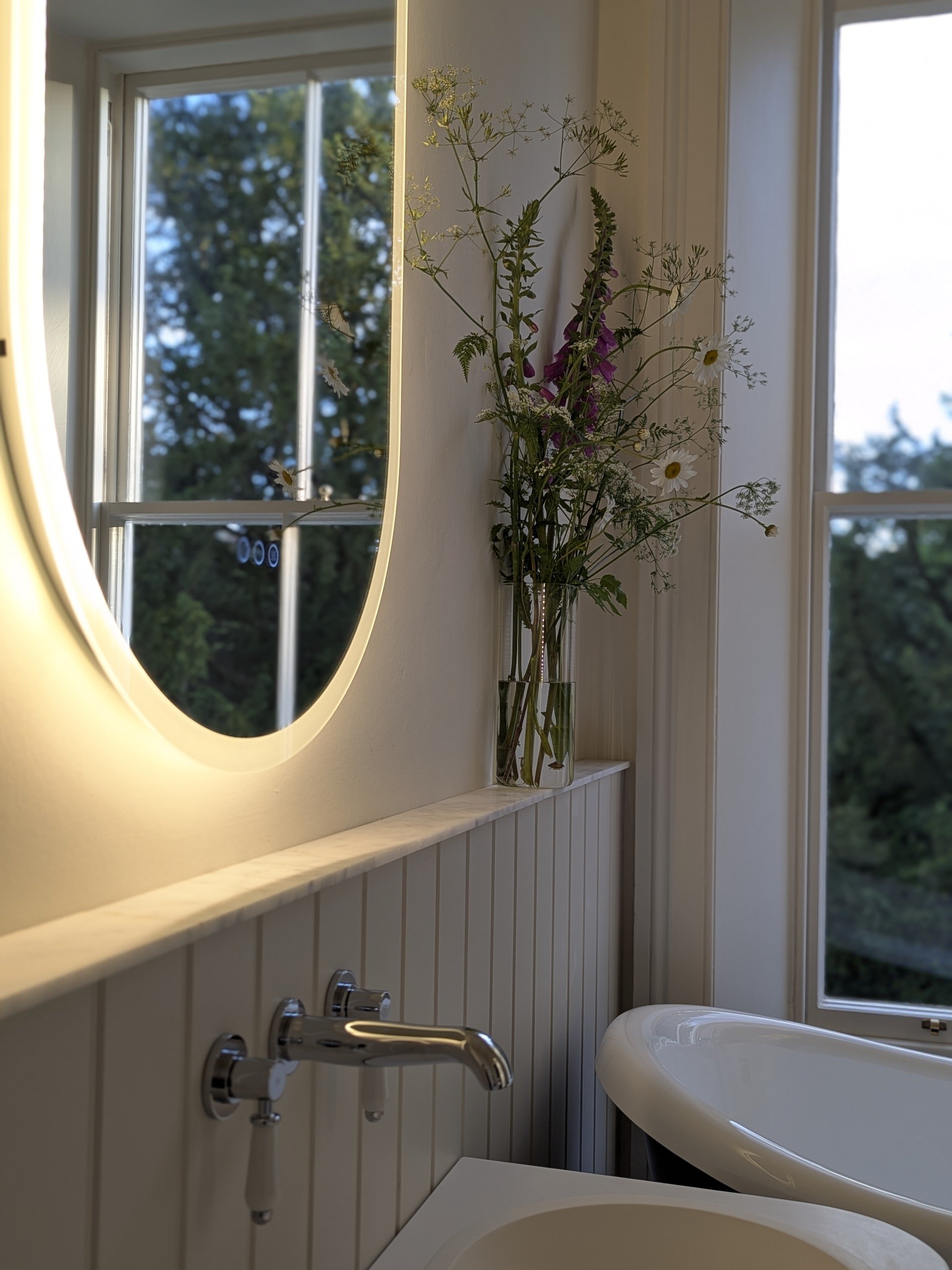 Luxury period bathroom design at 3 Banks Terrace, a premium townhouse for sale in Hurworth, Darlington, featuring a modern freestanding oval bath and a back-lit statement mirror.