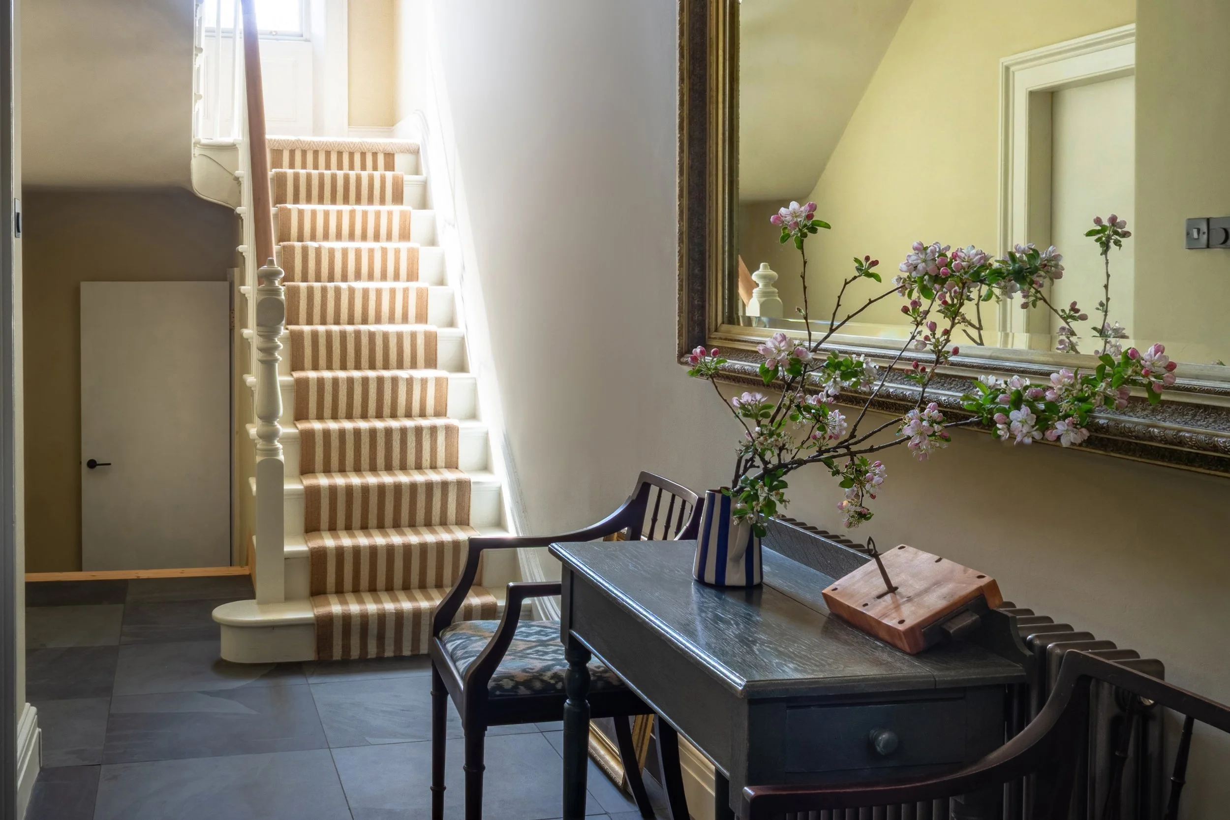 Elegant entrance hall featuring a traditional staircase with a classic striped runner carpet at 3 Banks Terrace, a premium renovated townhouse for sale in Hurworth.