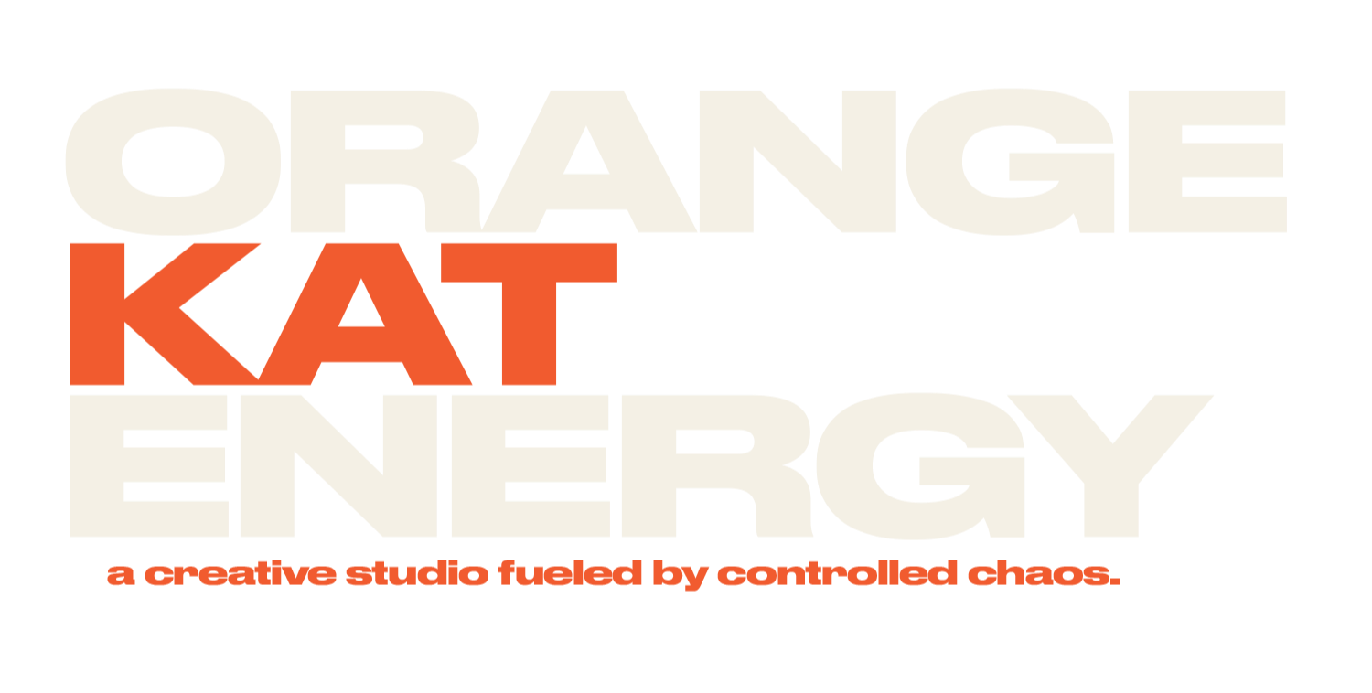 The logo for Orange Kat Energy, a creative studio fueled by controlled chaos, featuring the stylized text 'ORANGE KAT ENERGY' with 'KAT' in orange, and the tagline 'a creative studio fueled by controlled chaos' in smaller orange font.
