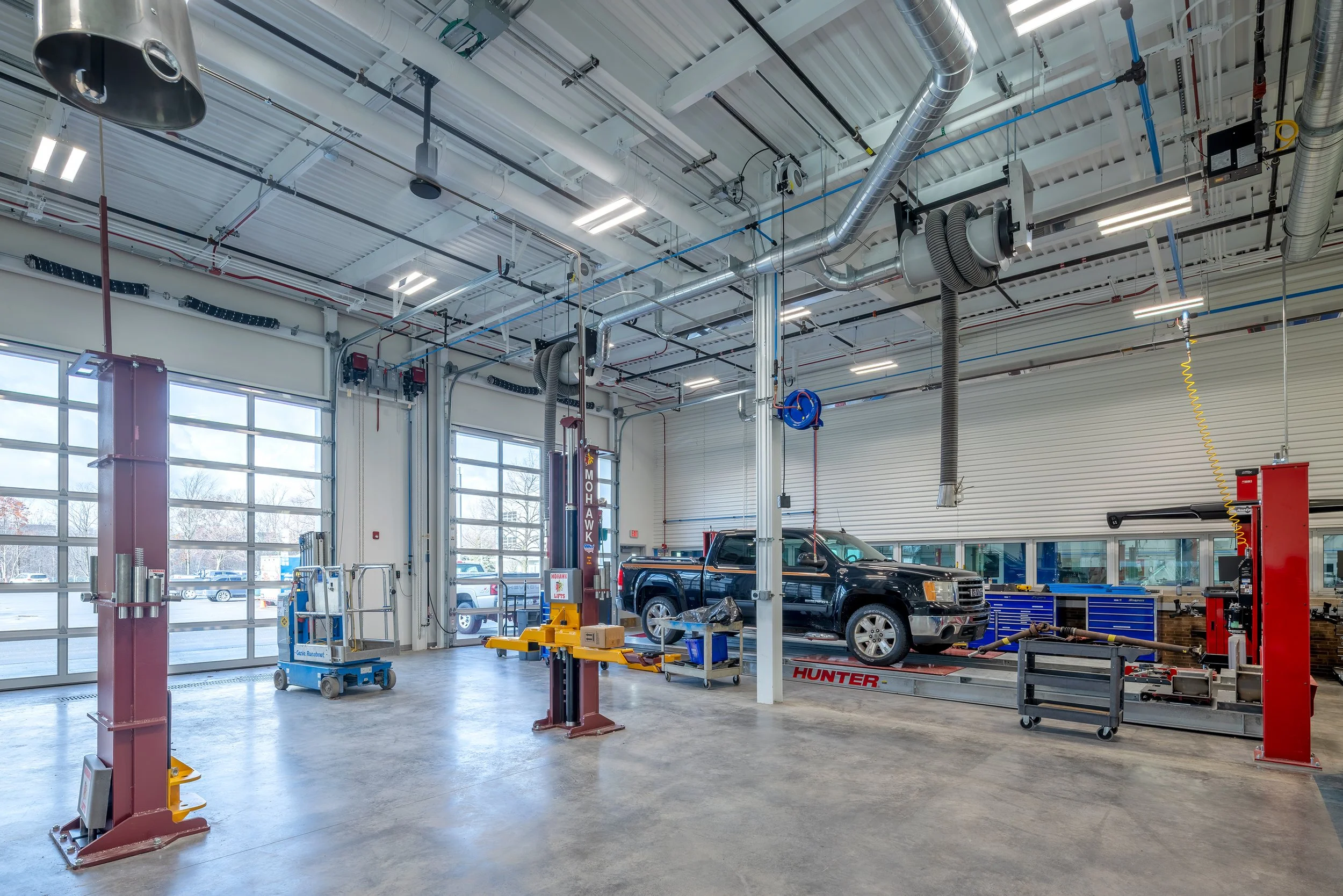 Automotive technology lab with vehicle lifts, service bays, and instructional equipment.