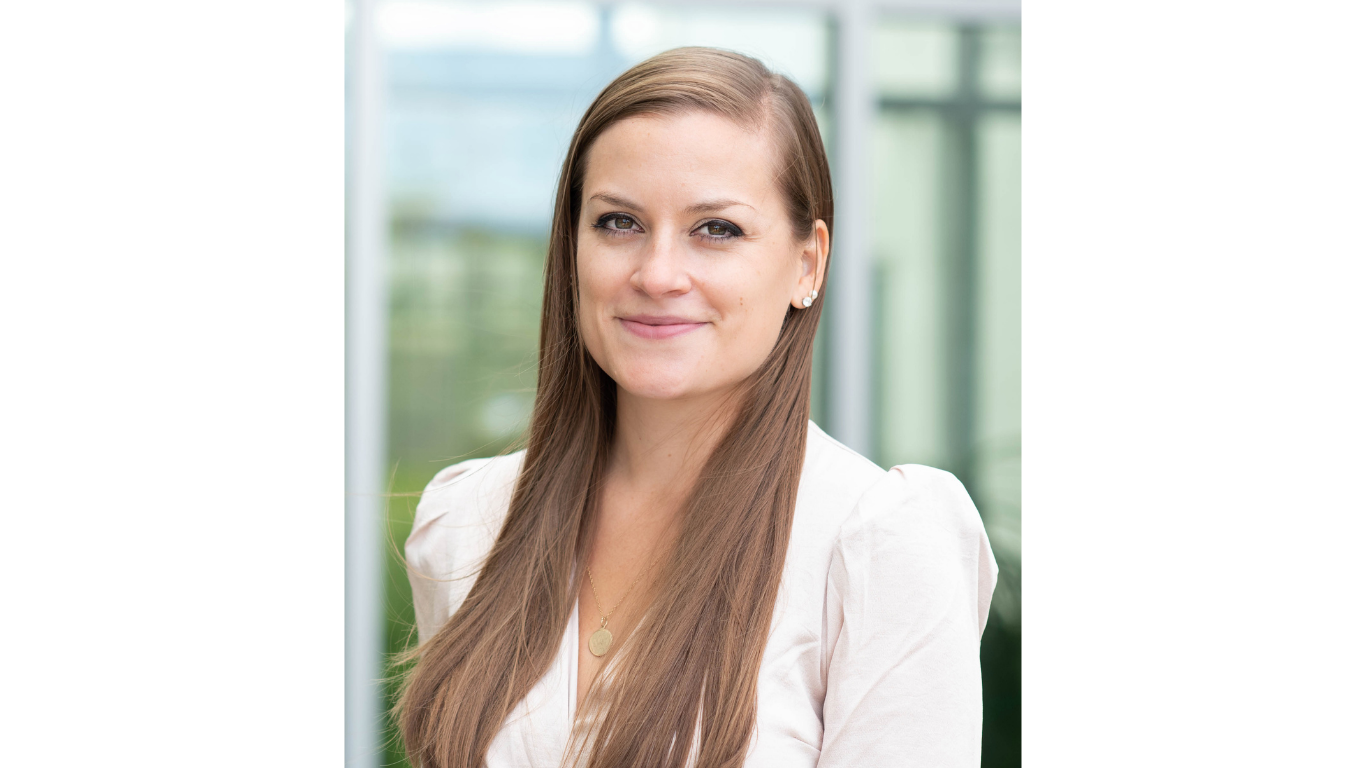 1. Professional headshot of a woman with long brown hair wearing a light-colored blouse.            Is this conversation helpful so far?