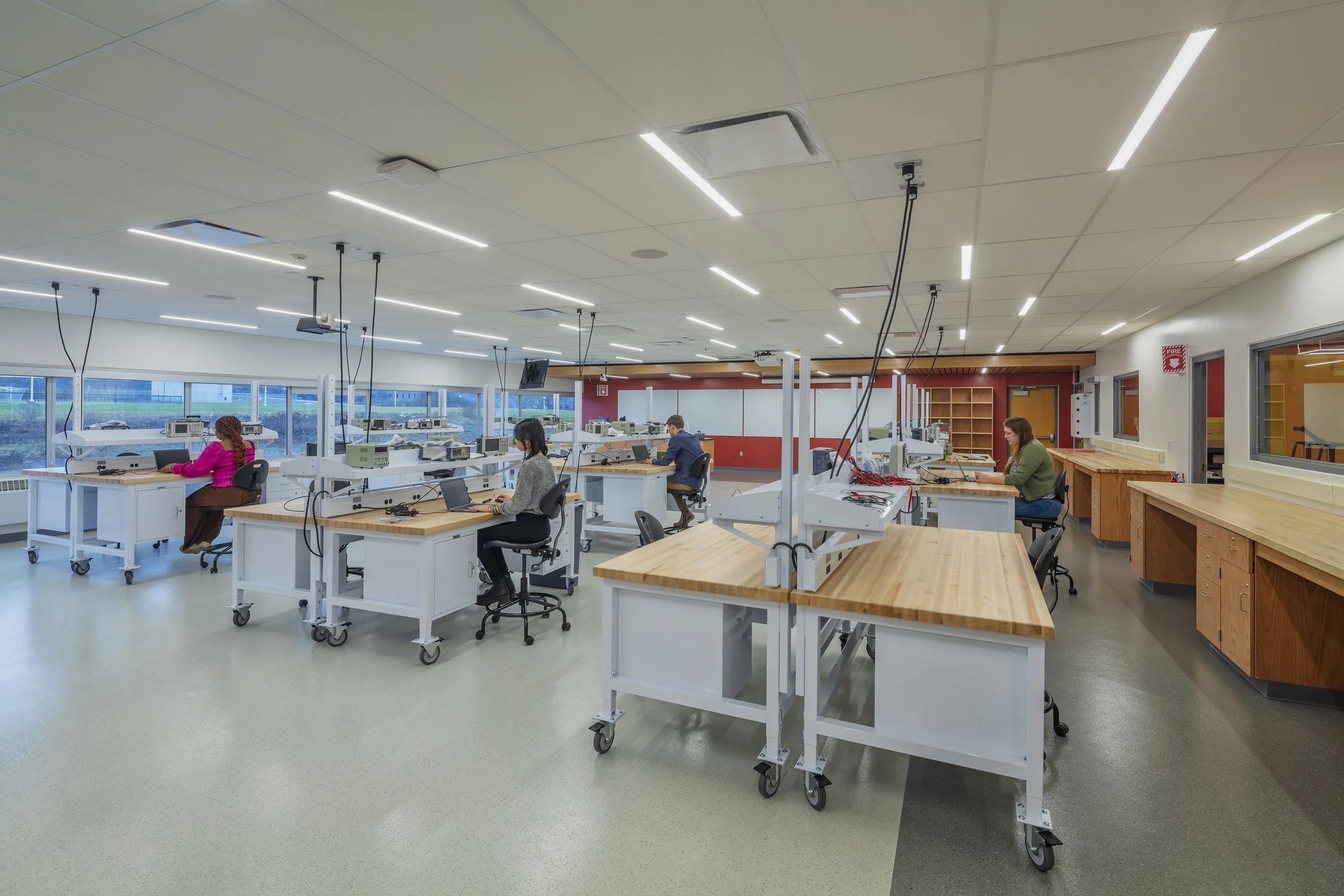 Flexible teaching laboratory with movable workstations, overhead utilities, and perimeter work surfaces.