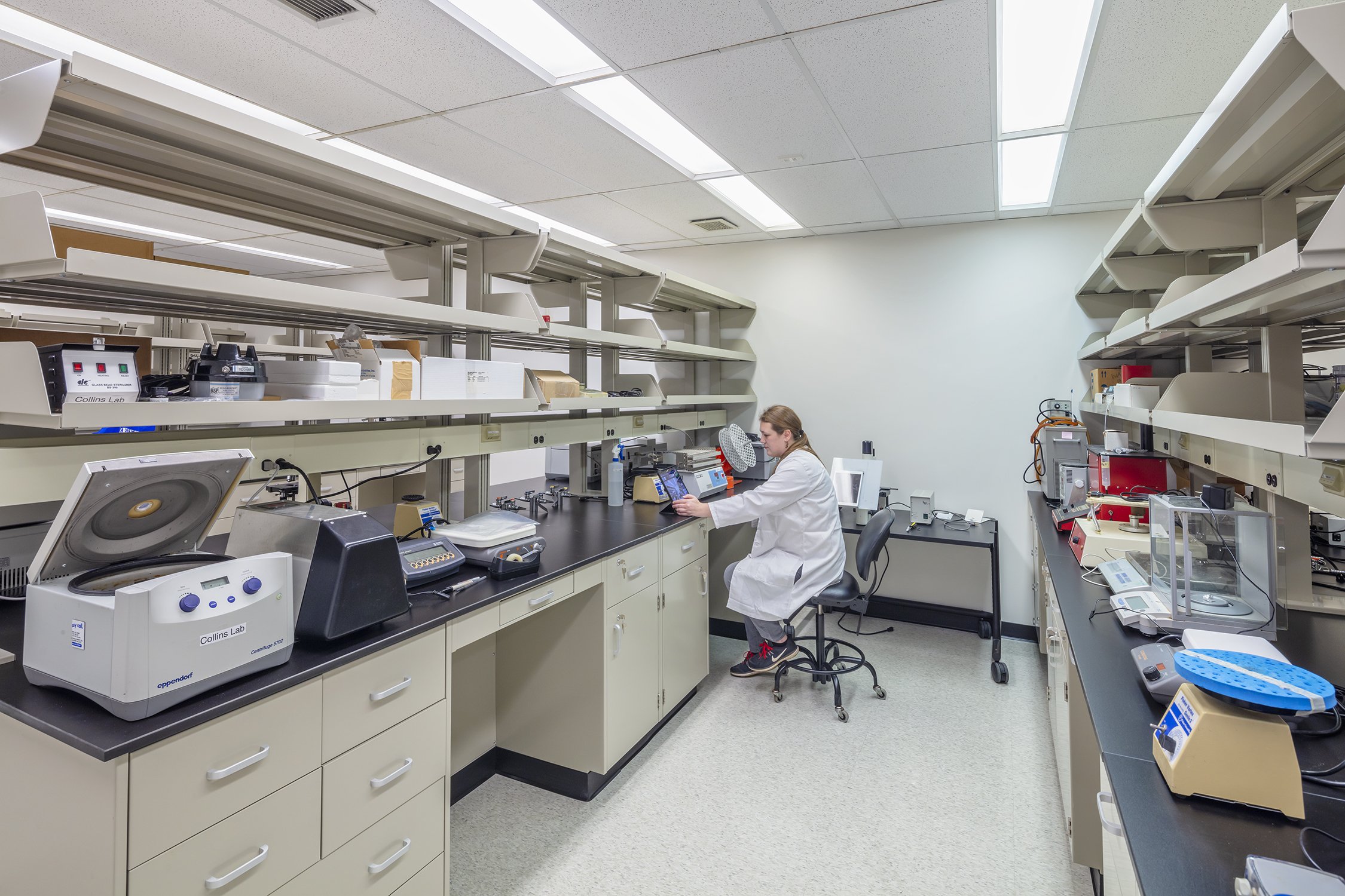 Researcher conducting materials testing in a Cornell University laboratory.