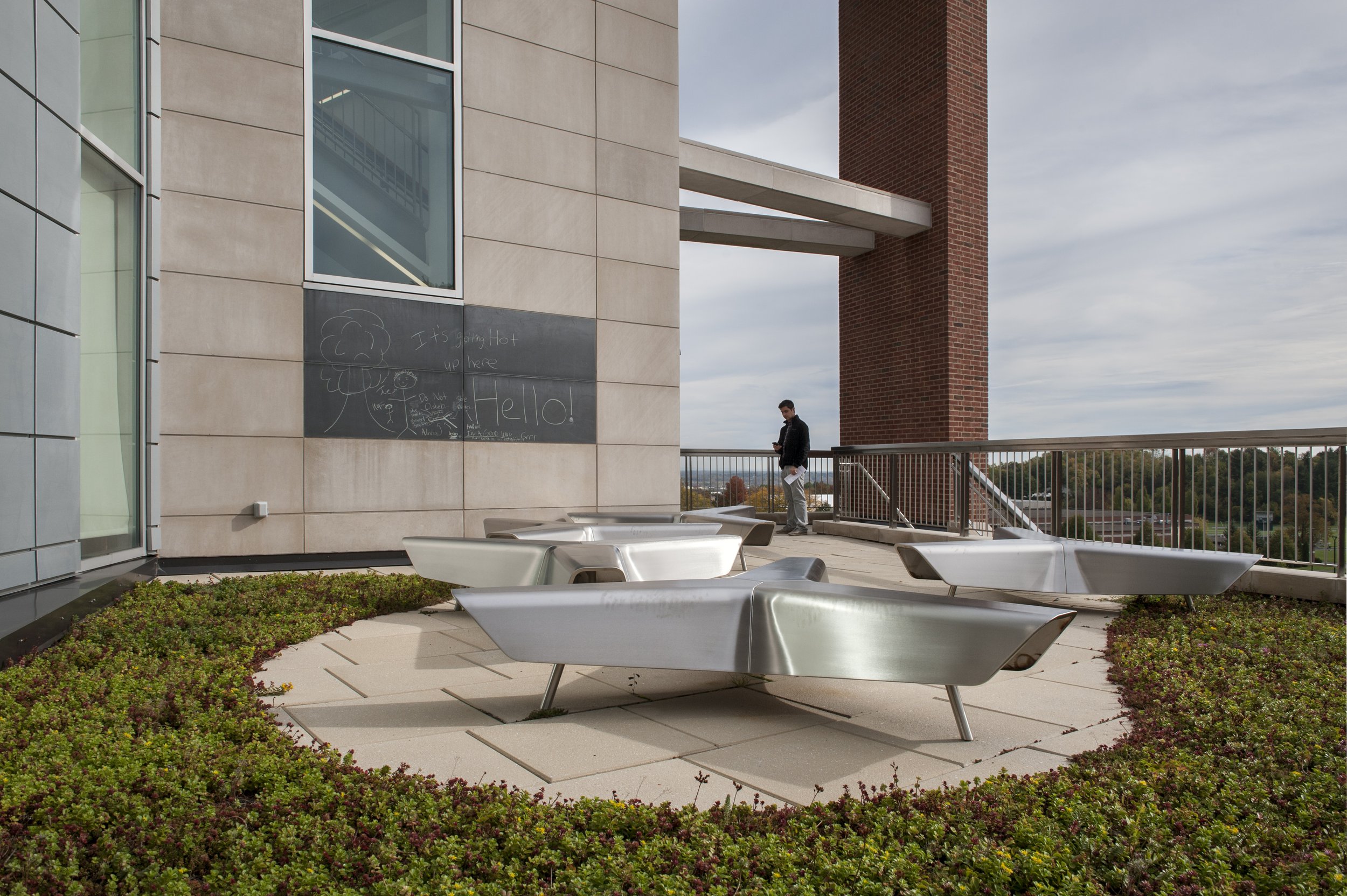 Outdoor terrace with integrated seating and green roof overlooking the Le Moyne College campus.