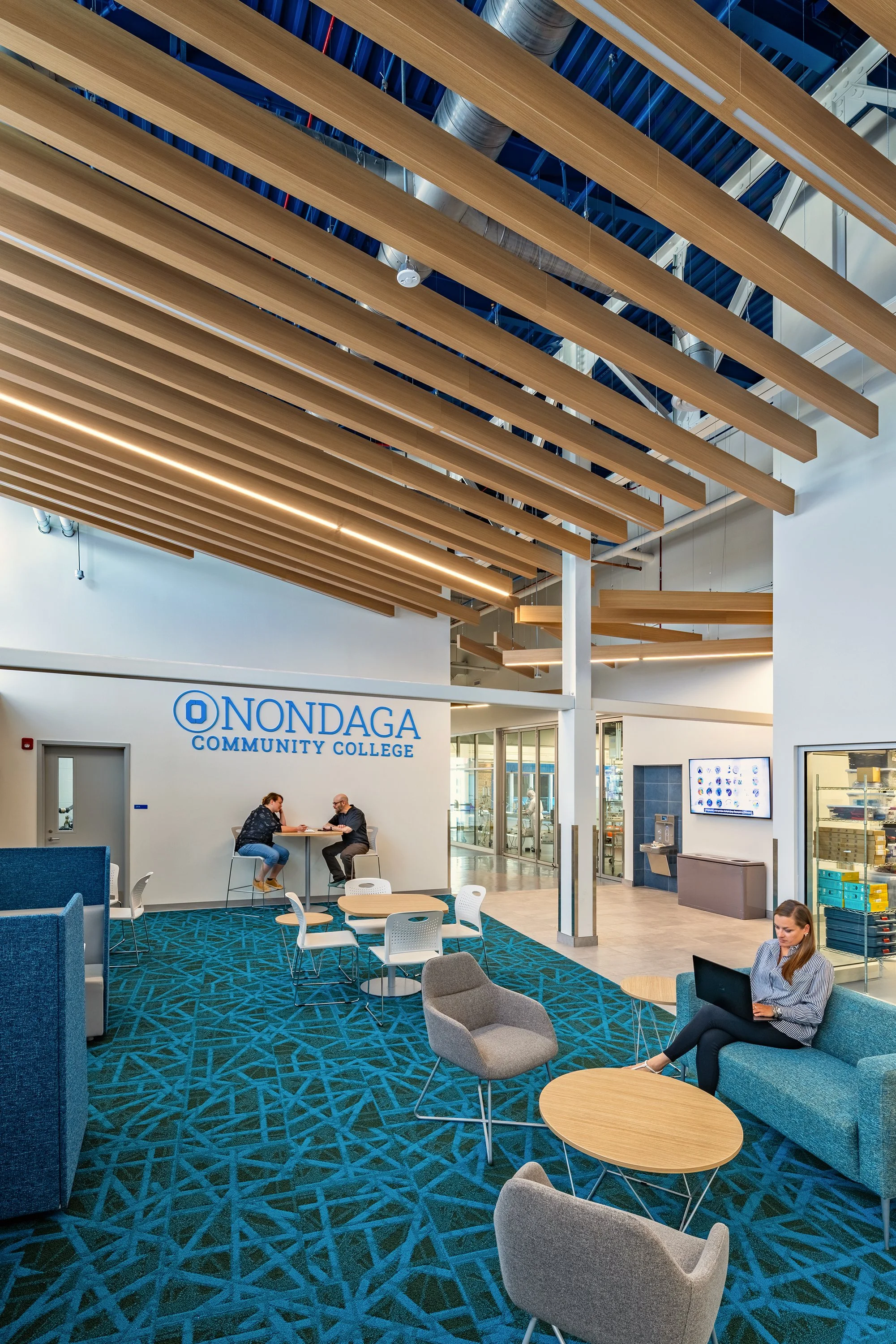 Collaborative student commons with lounge seating and study areas at Whitney Applied Technology Center.