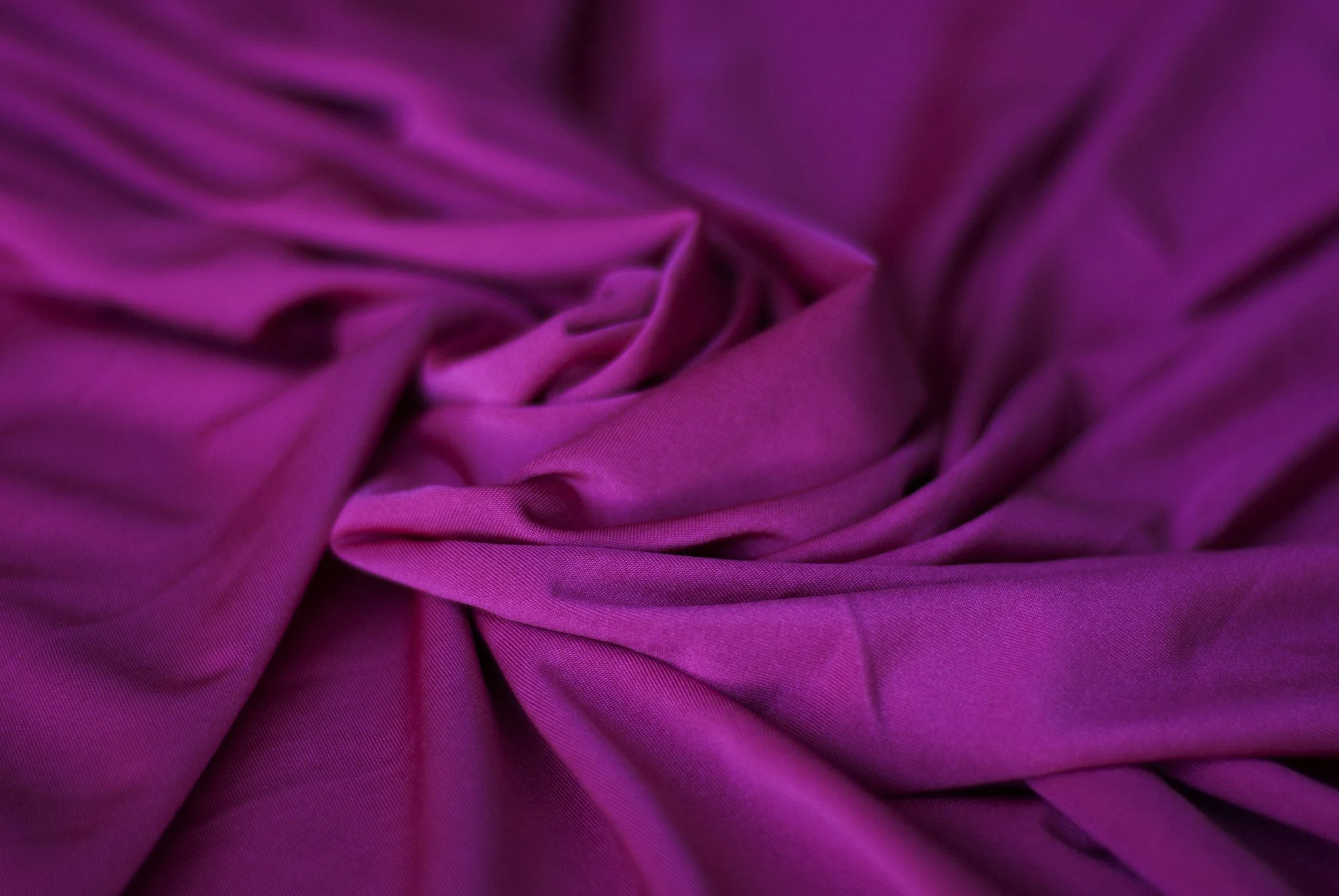 Close-up of rich purple fabric gathered into soft folds.