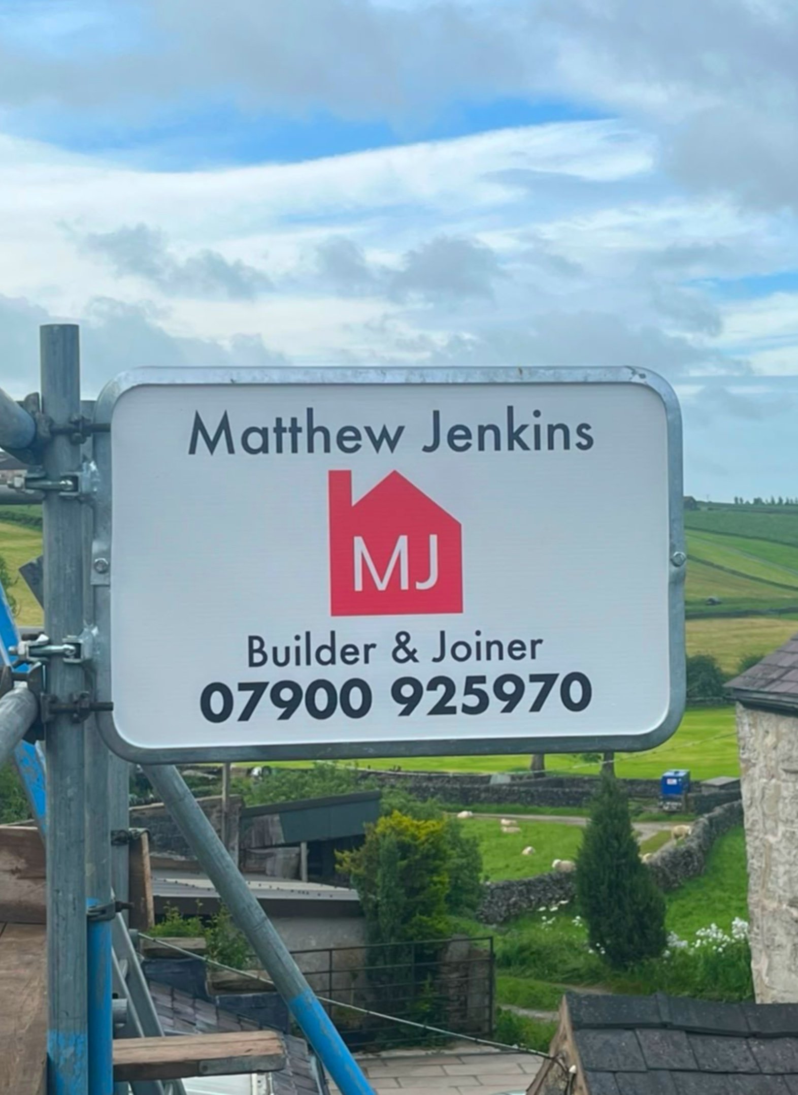 Matthew Jenkins Builder and Joiner. Buxton, High Peak, Derbyshire, Cheshire, Staffordshire. Scaffolding sign with red house logo.