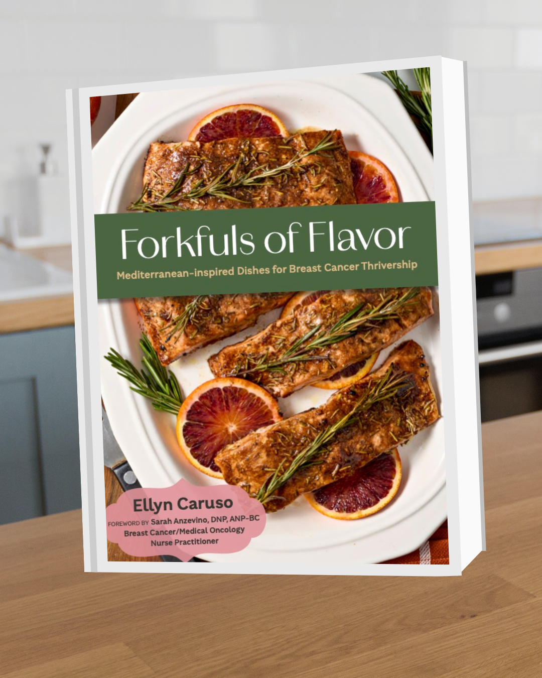 Book titled 'Forkfuls of Flavor' featuring Mediterranean-inspired dishes for breast cancer thrivership; cover showcases cooked salmon garnished with herbs, blood orange slices, and rosemary on a white plate