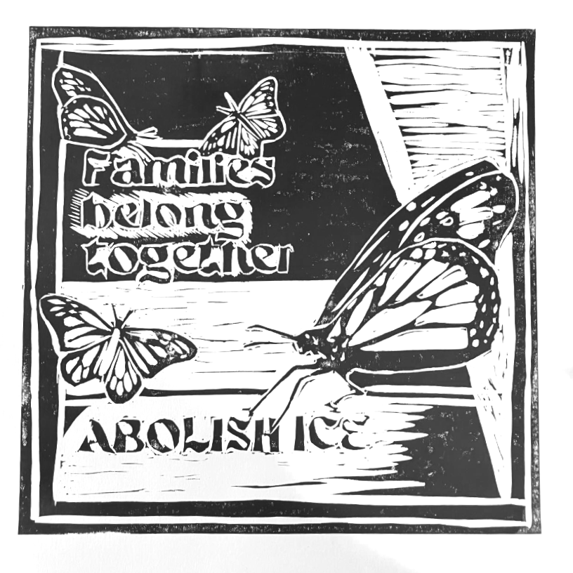 A sculpture of butterflies with the words "Families belong together" and "Abolish ICE".