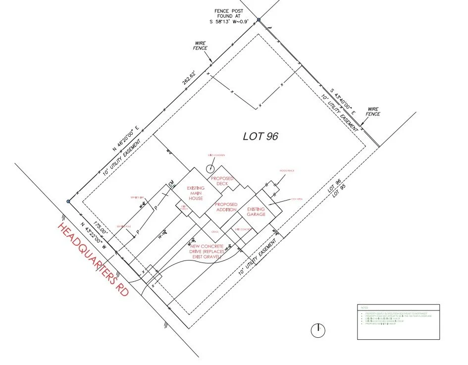 A detailed site plan for a residential lot showing existing and proposed structures, fencing, driveways, and utility easements, including a main house, garage, deck, and driveway with notes on construction details.