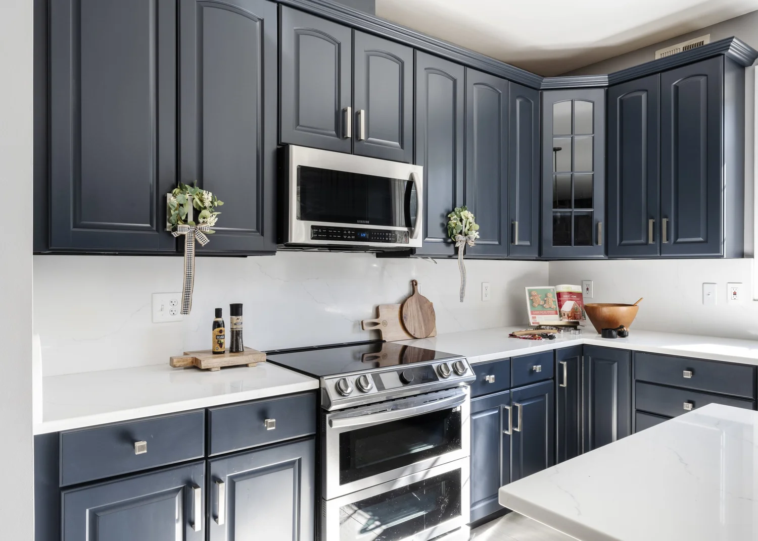 Kitchen with custom blue cabinetry and white countertops