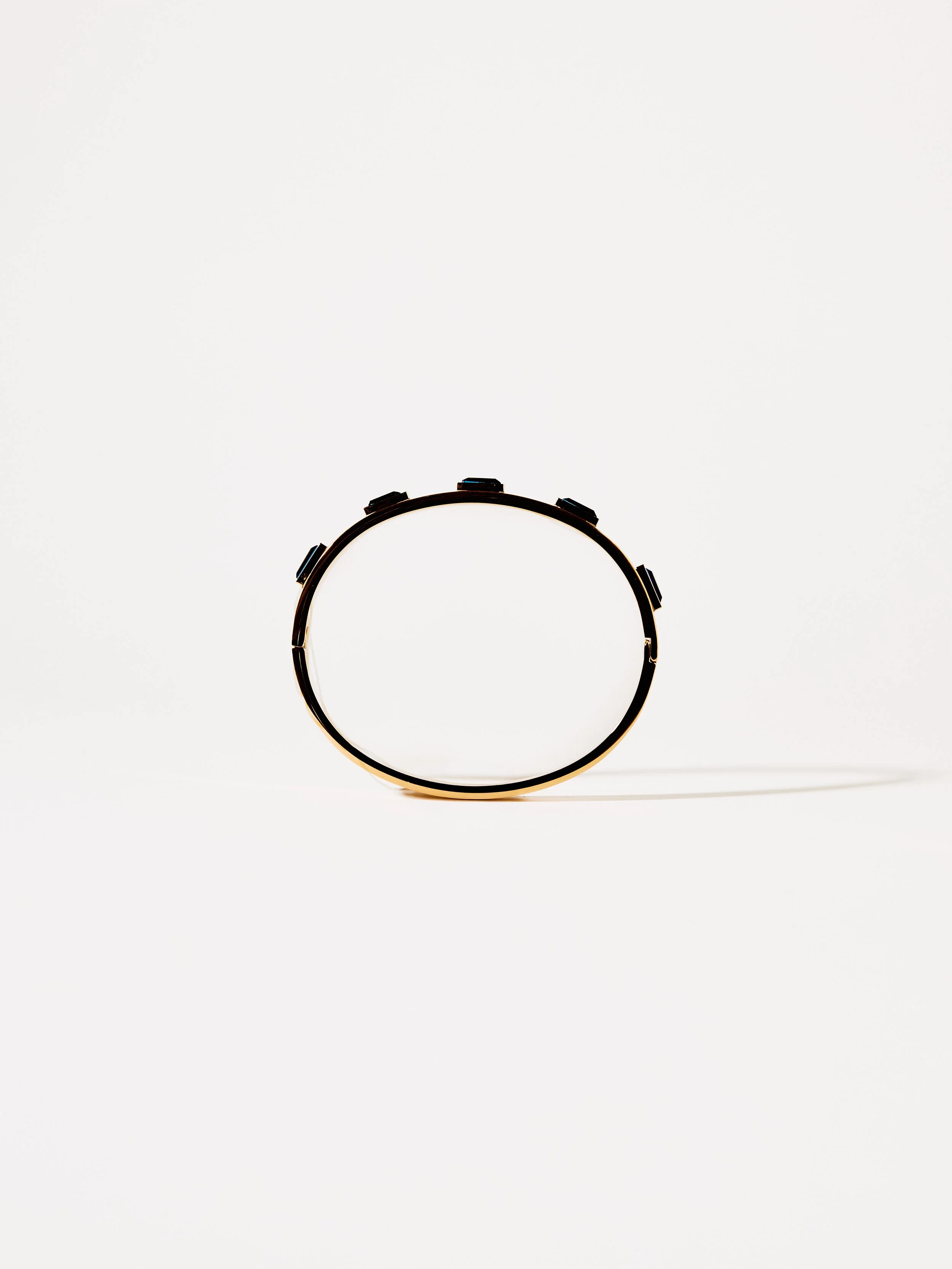 A black wristwatch with a round face and multiple dials, placed on a plain white background.
