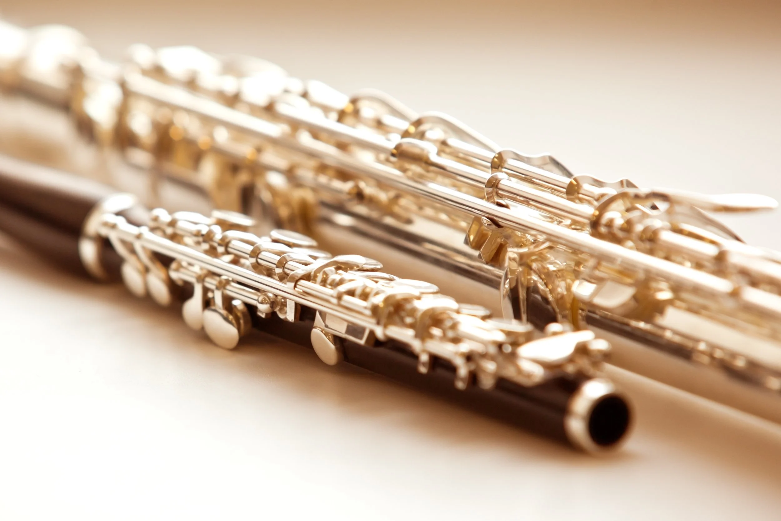 Close-up of shiny metal flutes stacked together.