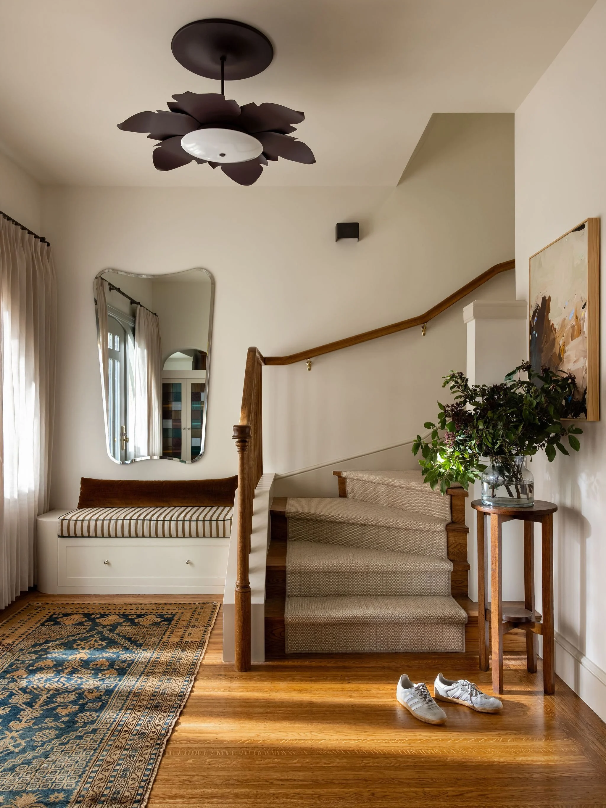 Your entryway sets the scene for your home, might as well make it a vibe 🫶🏼 We added drapery to the front door and sidelites for privacy at night and it really makes the space more like a room. The custom stained glass cabinet doors are simply the 