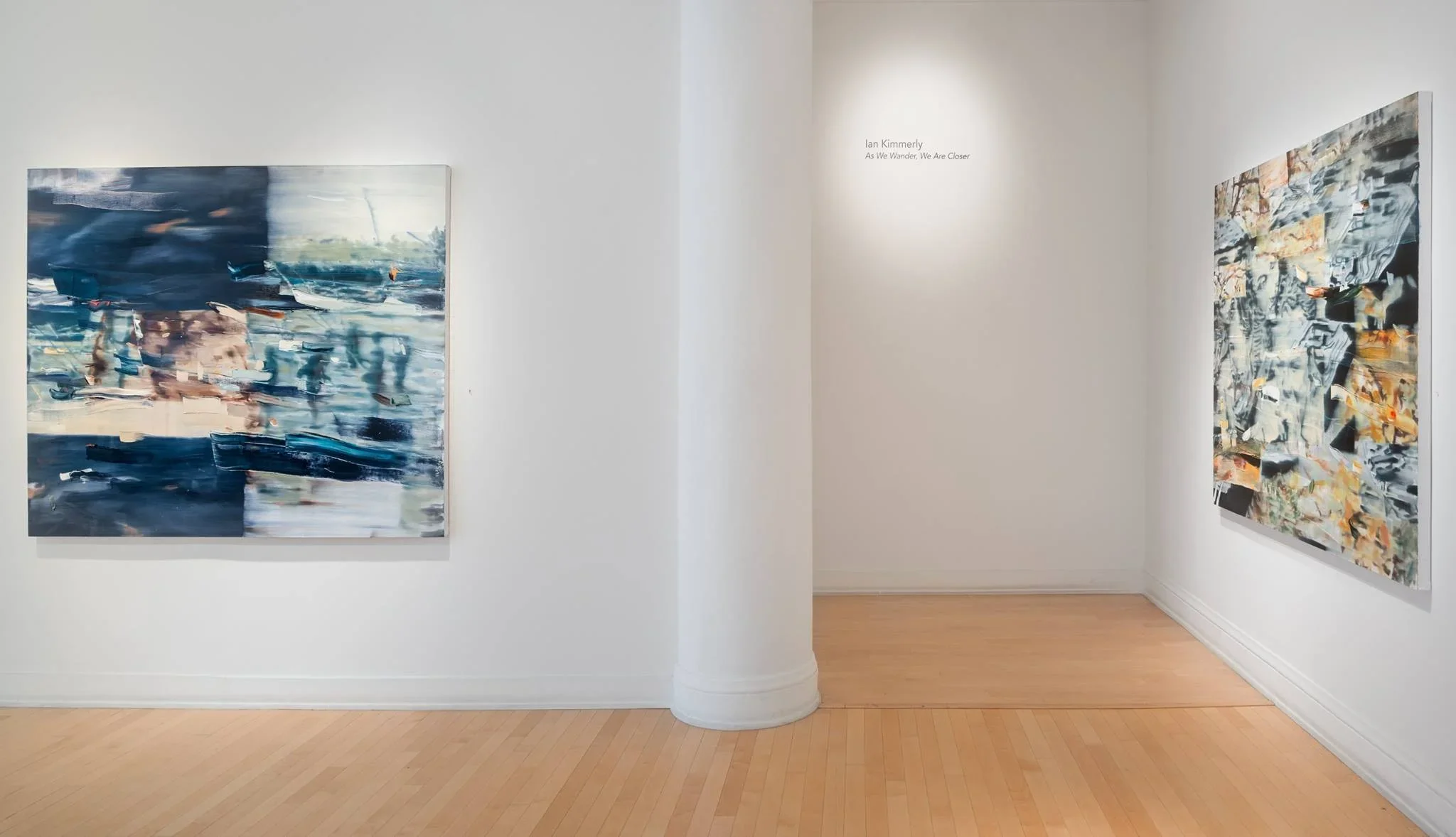 Two abstract paintings displayed in an art gallery with white walls and wooden floors.