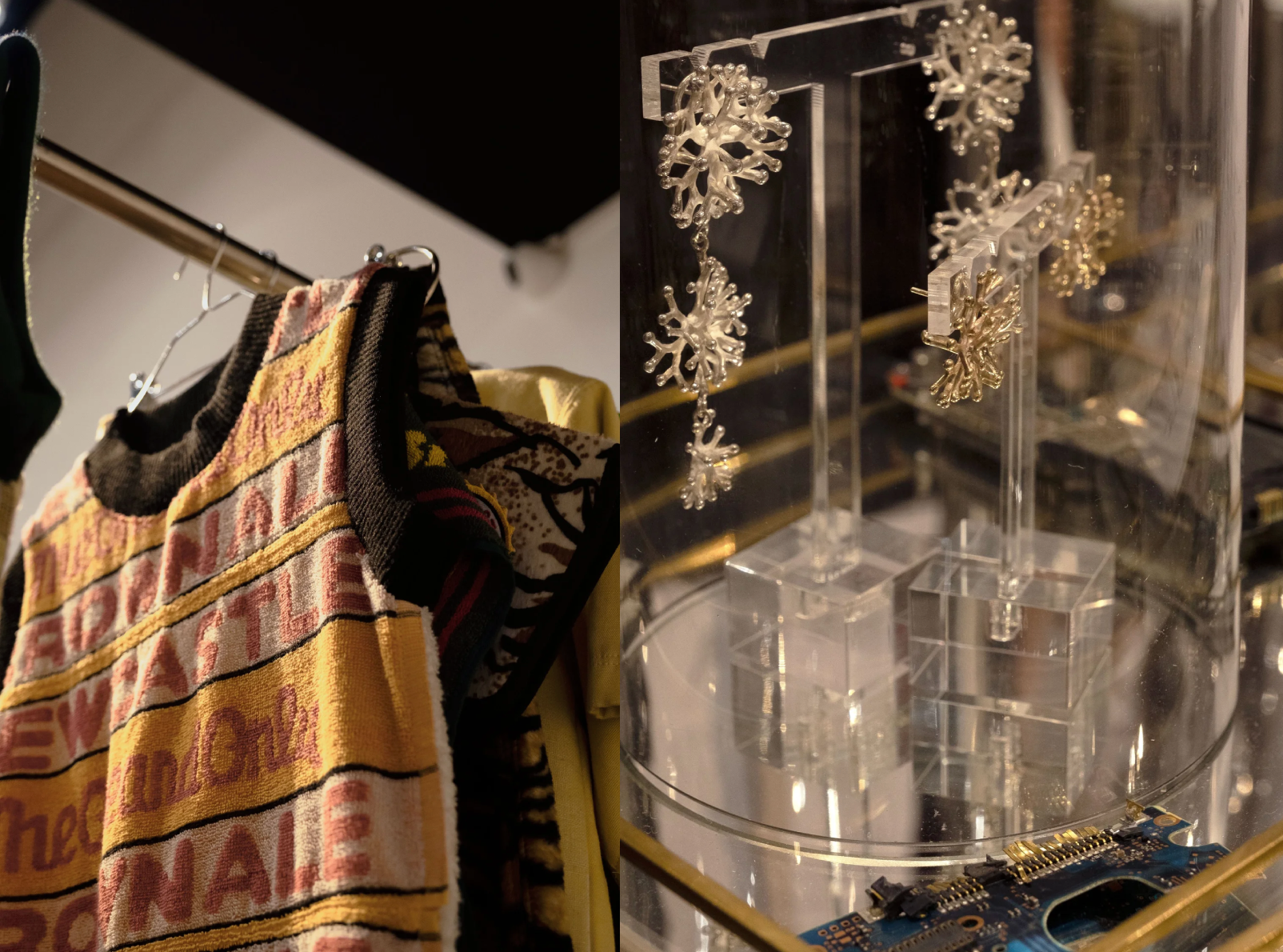 Clothing on hangers and jewelry on display in a store.