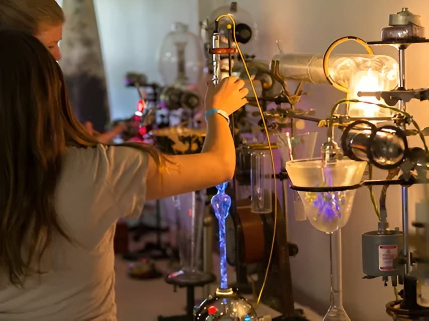 Hand reaching for science equipment