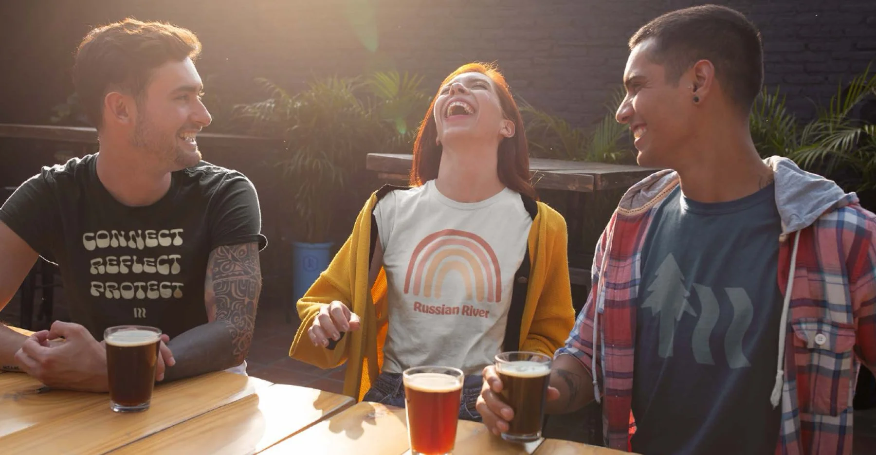 Russian river shirts on models sitting around a table
