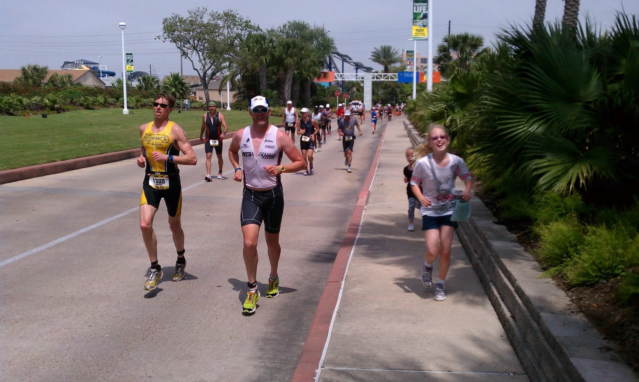 David Knight, training for his fourth Ironman triathlon in 2011, being paced by his 9 year old daughter on the sidewalk