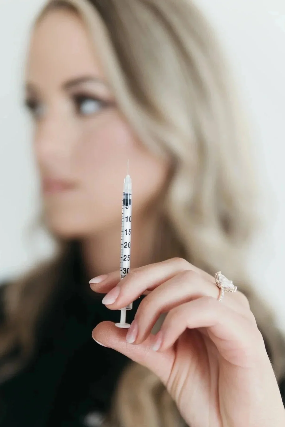 Mikayla Wells, PA-C, holding a syringe at Southwest Aesthetics+ in Lawton, OK
