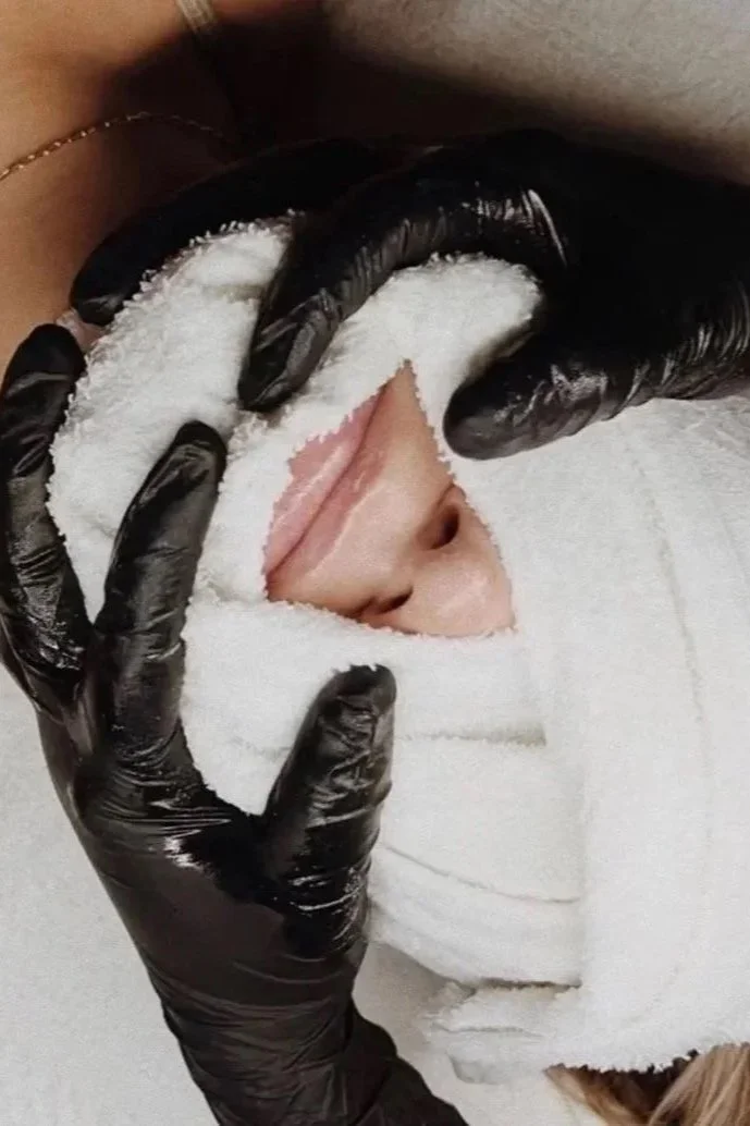Hot towel placed over a client’s face during a facial at Southwest Aesthetics+ in Lawton, OK