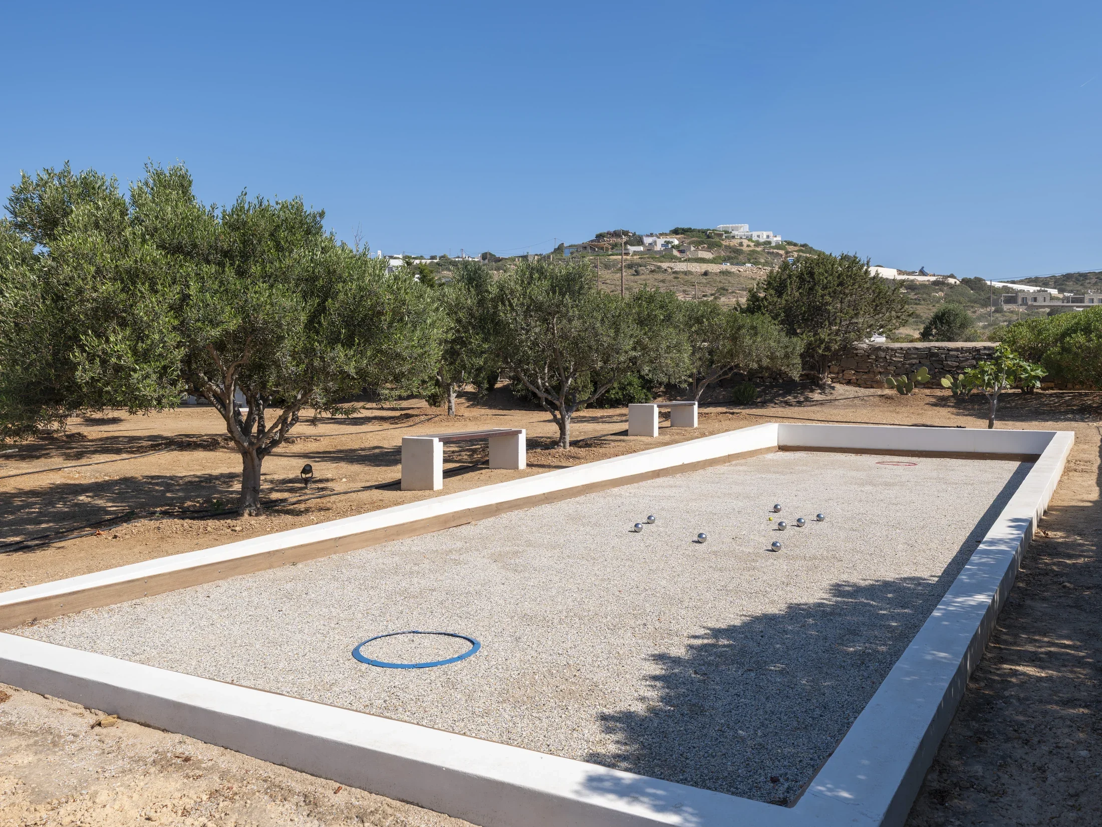 A side view of a private petanque court in a luxurious villa in Paros.