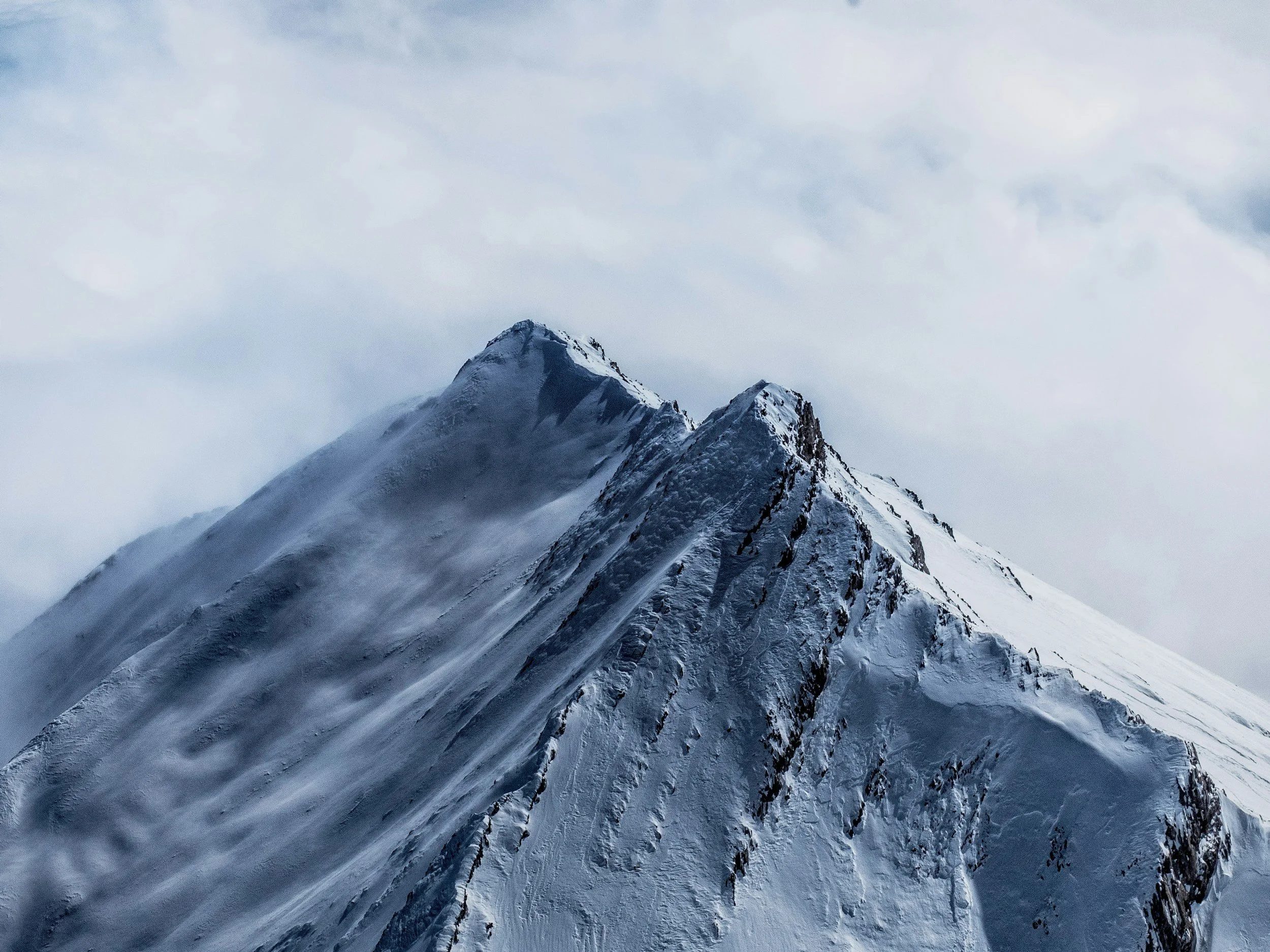 Snow-covered mountain peaks symbolizing the ambition and drive behind Maverick HQ's approach to business growth.